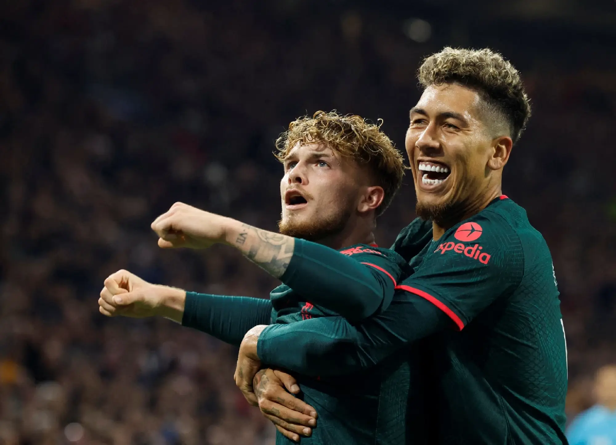Liverpool's Harvey Elliott celebrates scoring their third goal with Roberto Firmino REUTERS