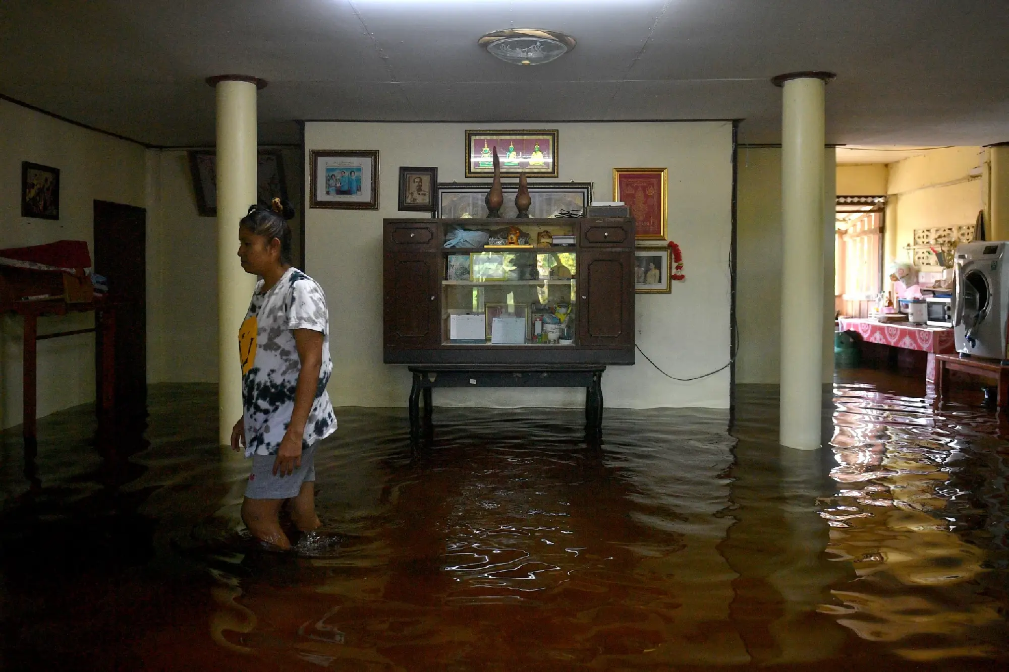 Officials battle through chest-high floods to deliver relief supplies in Central Thailand