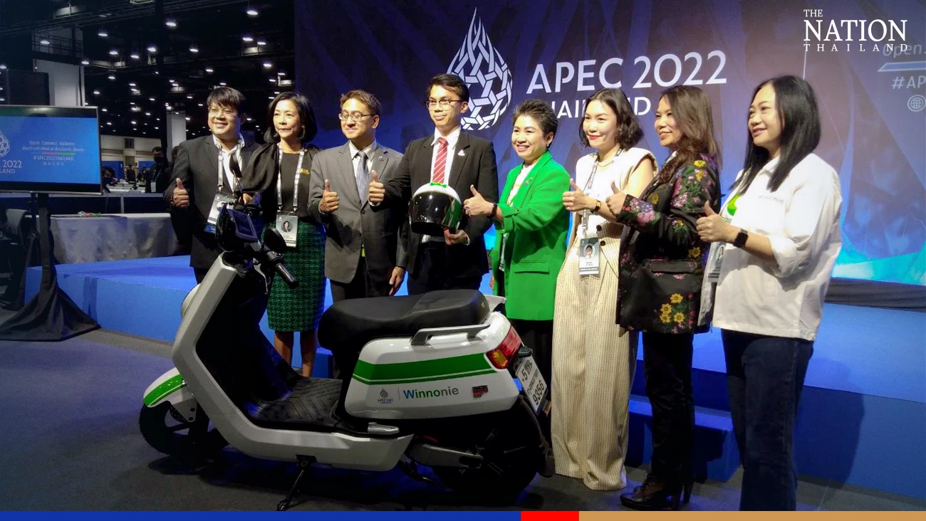 Foreign ministry officials, Tik Tok agents, and their partners pose for photos with one of the prizes, an electric motorcycle.