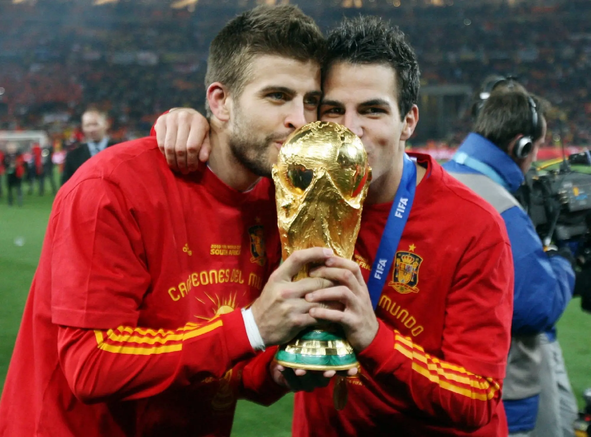 Spain's Gerard Pique and Cesc Fabregas celebrate winning the final with the trophy Action Images via Reuters