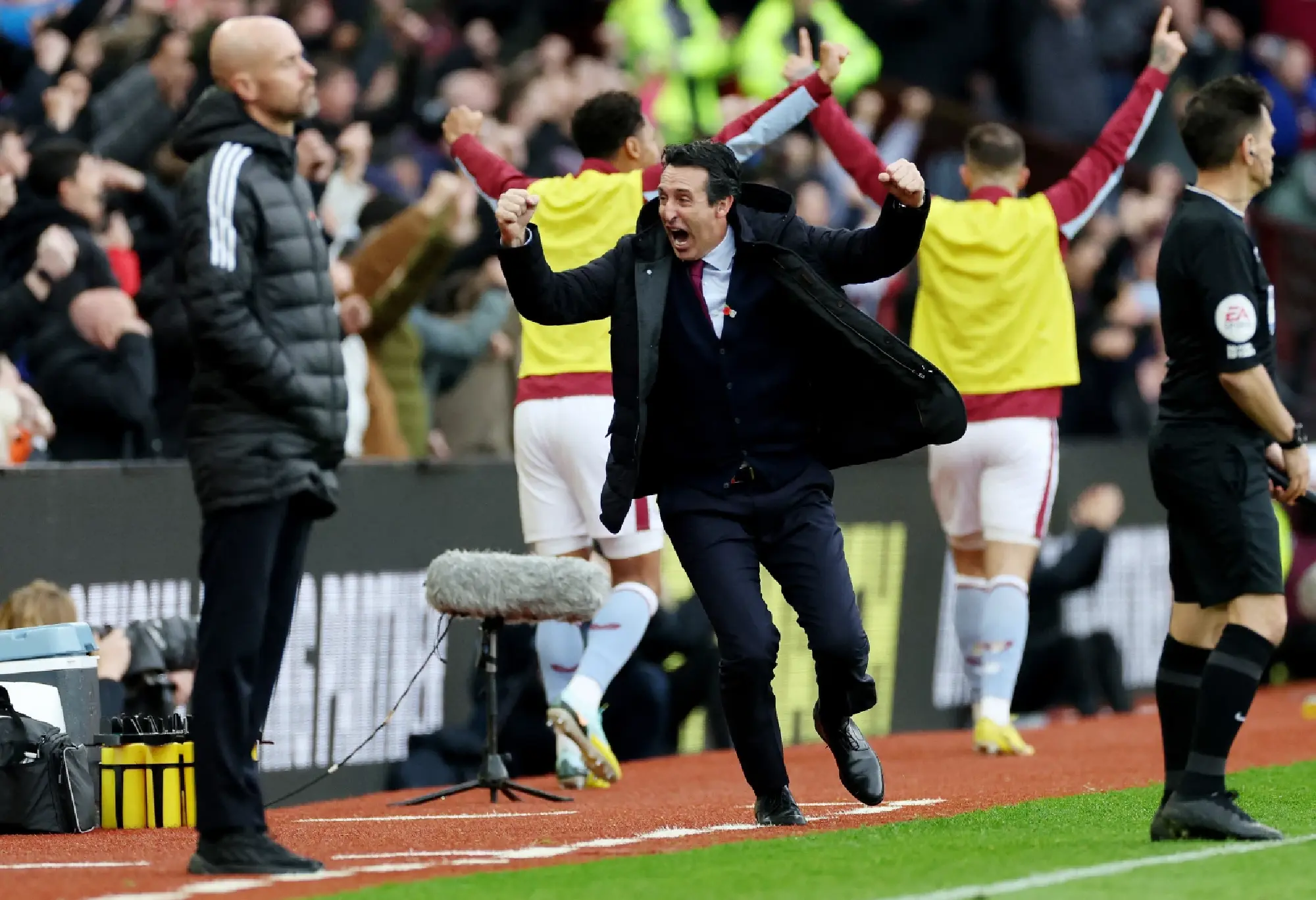 Aston Villa manager Unai Emery celebrates after Jacob Ramsey scores their third goal as Manchester United manager Erik ten Hag looks on