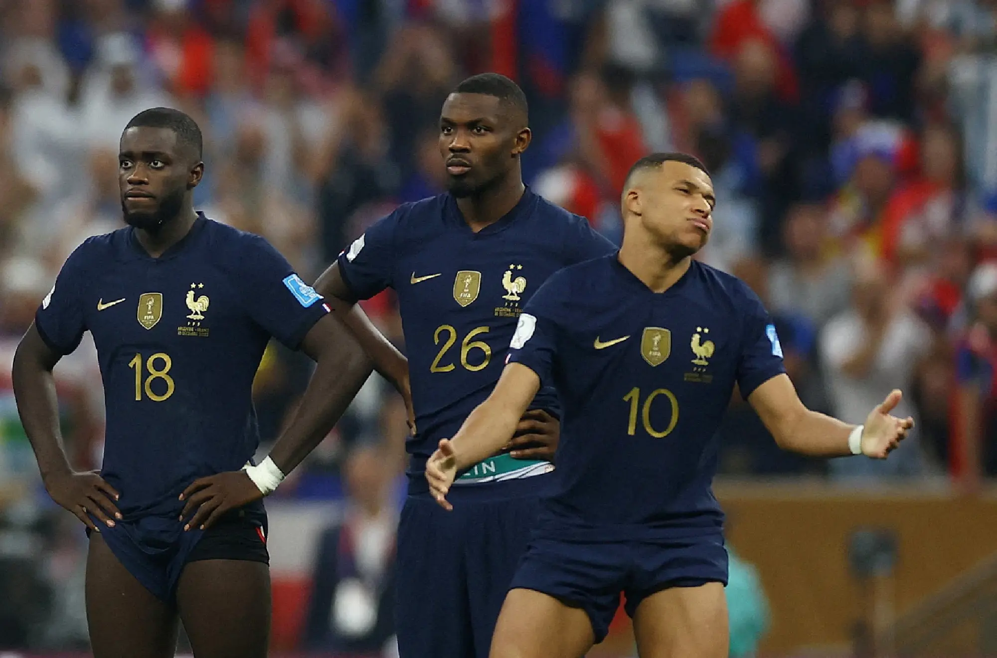 France's Kylian Mbappe reacts alongside Marcus Thuram and Dayot Upamecano during the penalty shootout