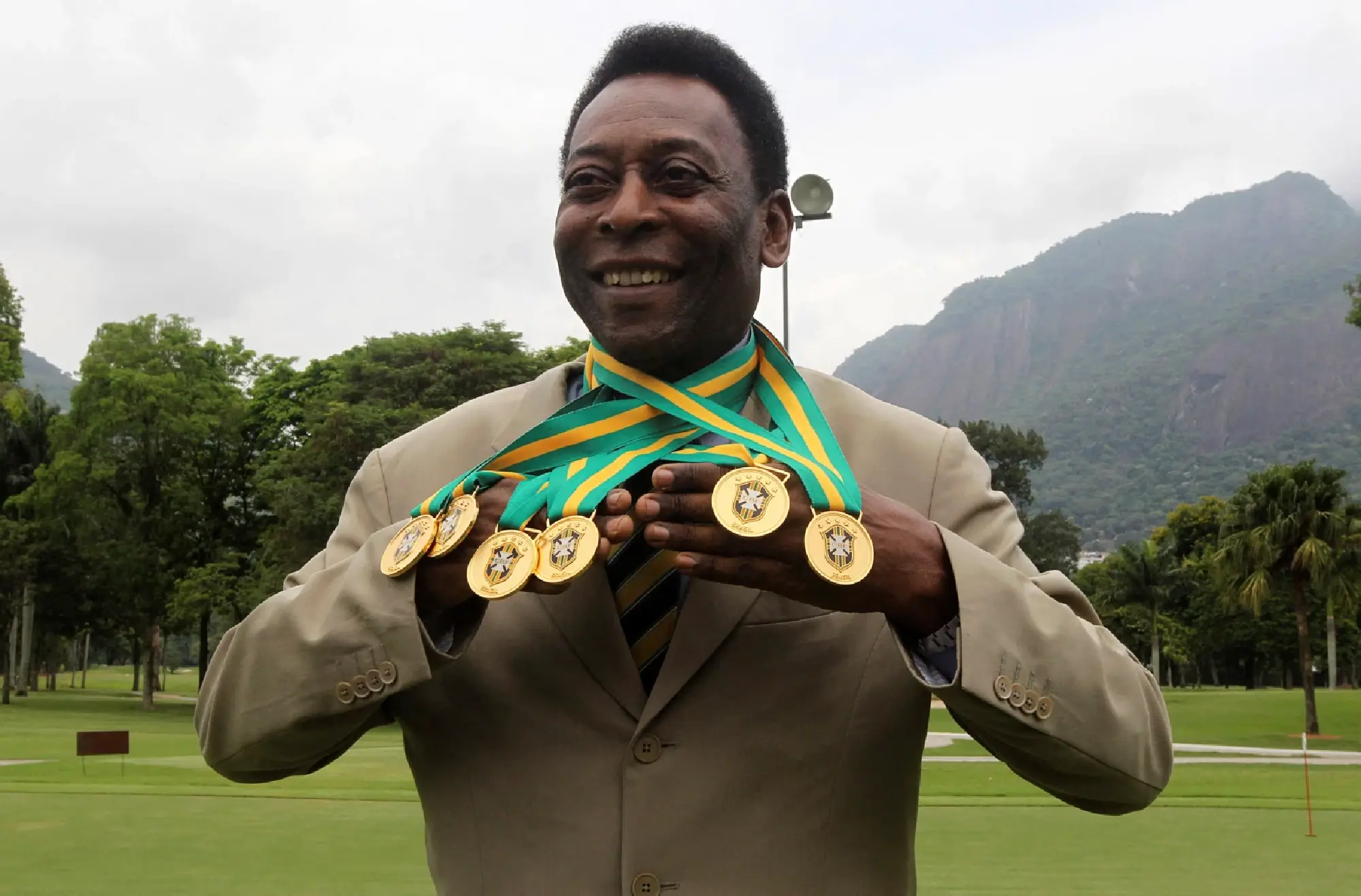 Brazilian soccer legend Pele shows off his six domestic championship medals at a Brazilian soccer confederation event recognising the previous incarnations of the Brazilian soccer championships in Rio de Janeiro, Brazil, December 22, 2010.