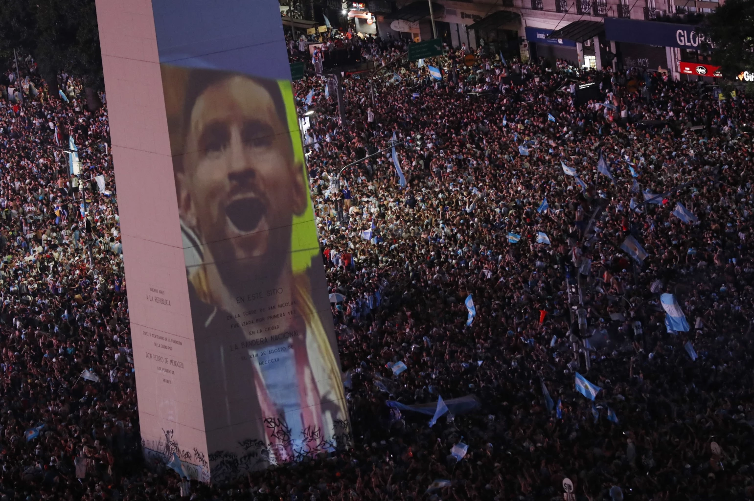  Argentina fans celebrate winning the World Cup at the Obelisk with an image of Lionel Messi and fireworks