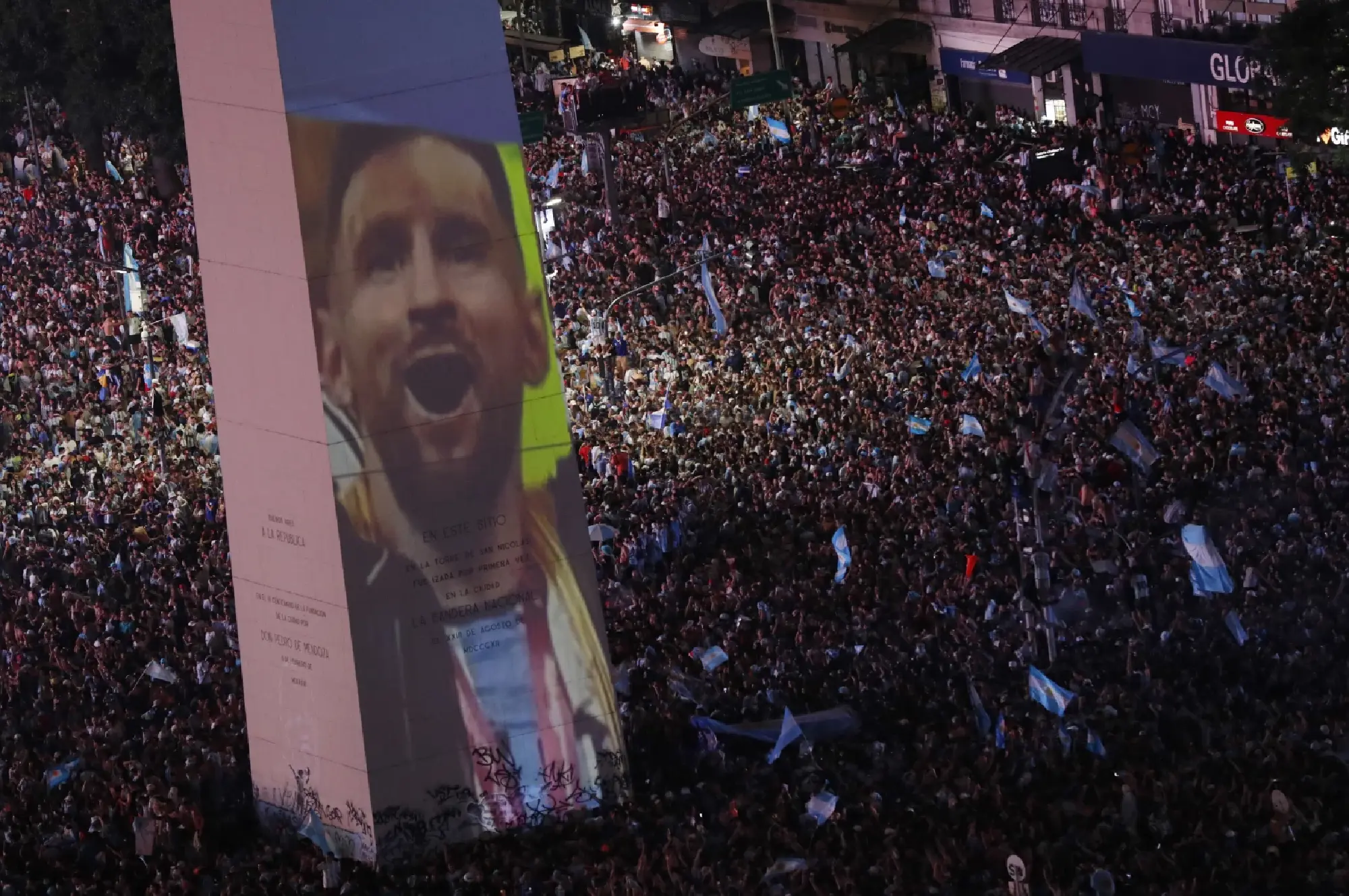  Argentina fans celebrate winning the World Cup at the Obelisk with an image of Lionel Messi and fireworks