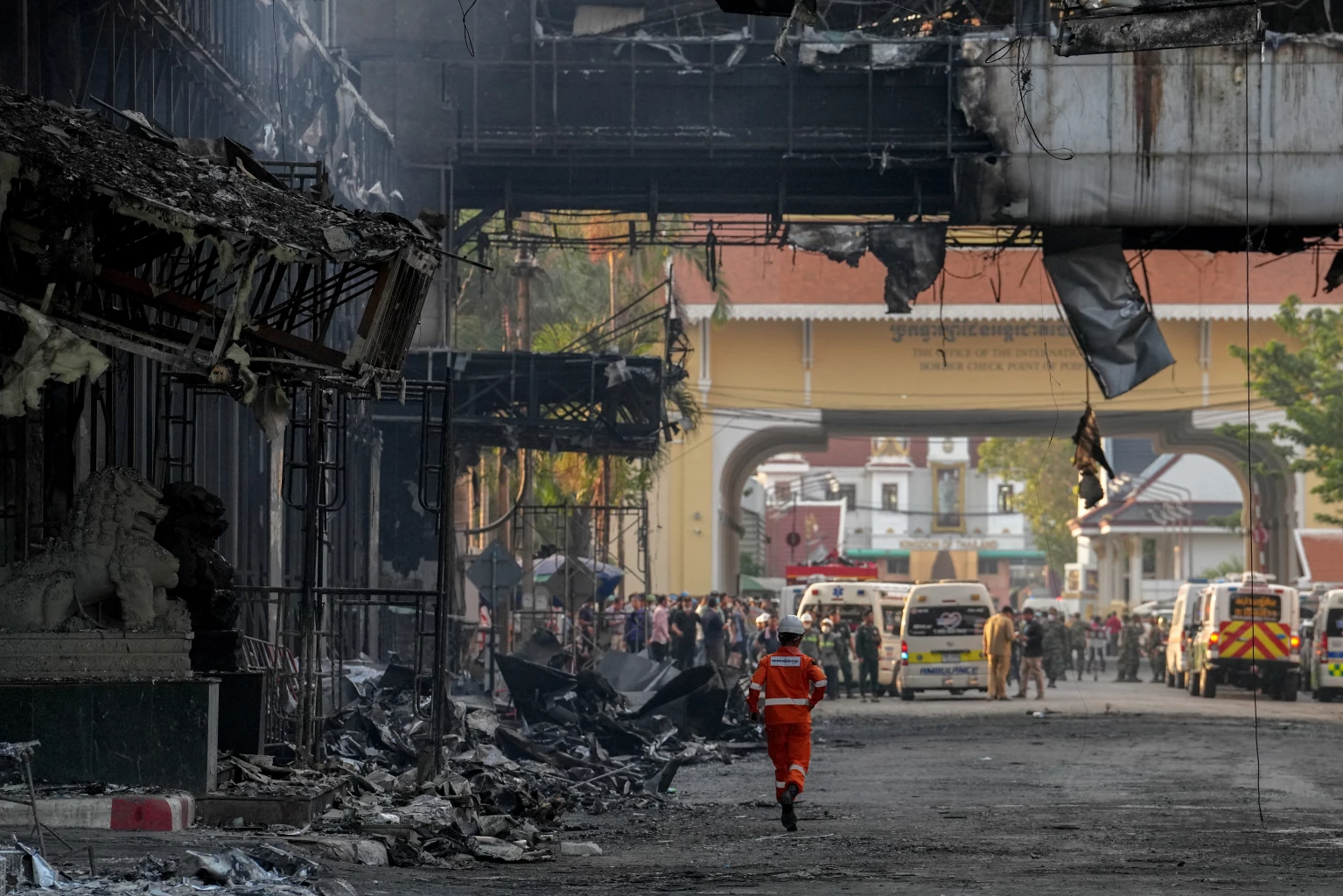 Thai and Cambodian rescuers gather in front of the Grand Diamond hotel-casino as they struggle to extricate dozens of people feared trapped after a fire broke, killing at least 10 and injuring dozens in Poipet near Thailand border, Cambodia, December 29, 2022. 