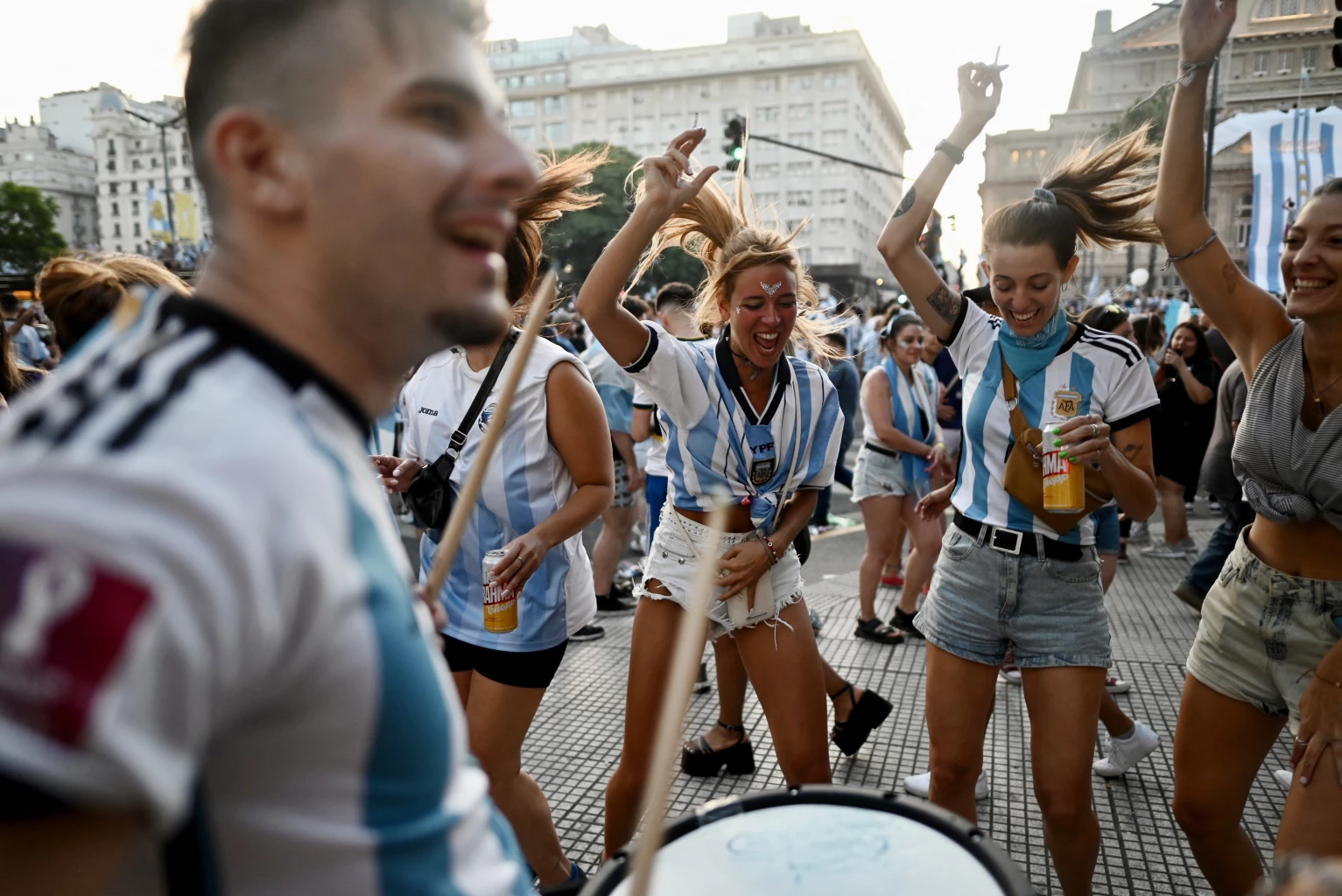 An Argentina fan holds a replica World Cup trophy as they celebrate winning the World Cup