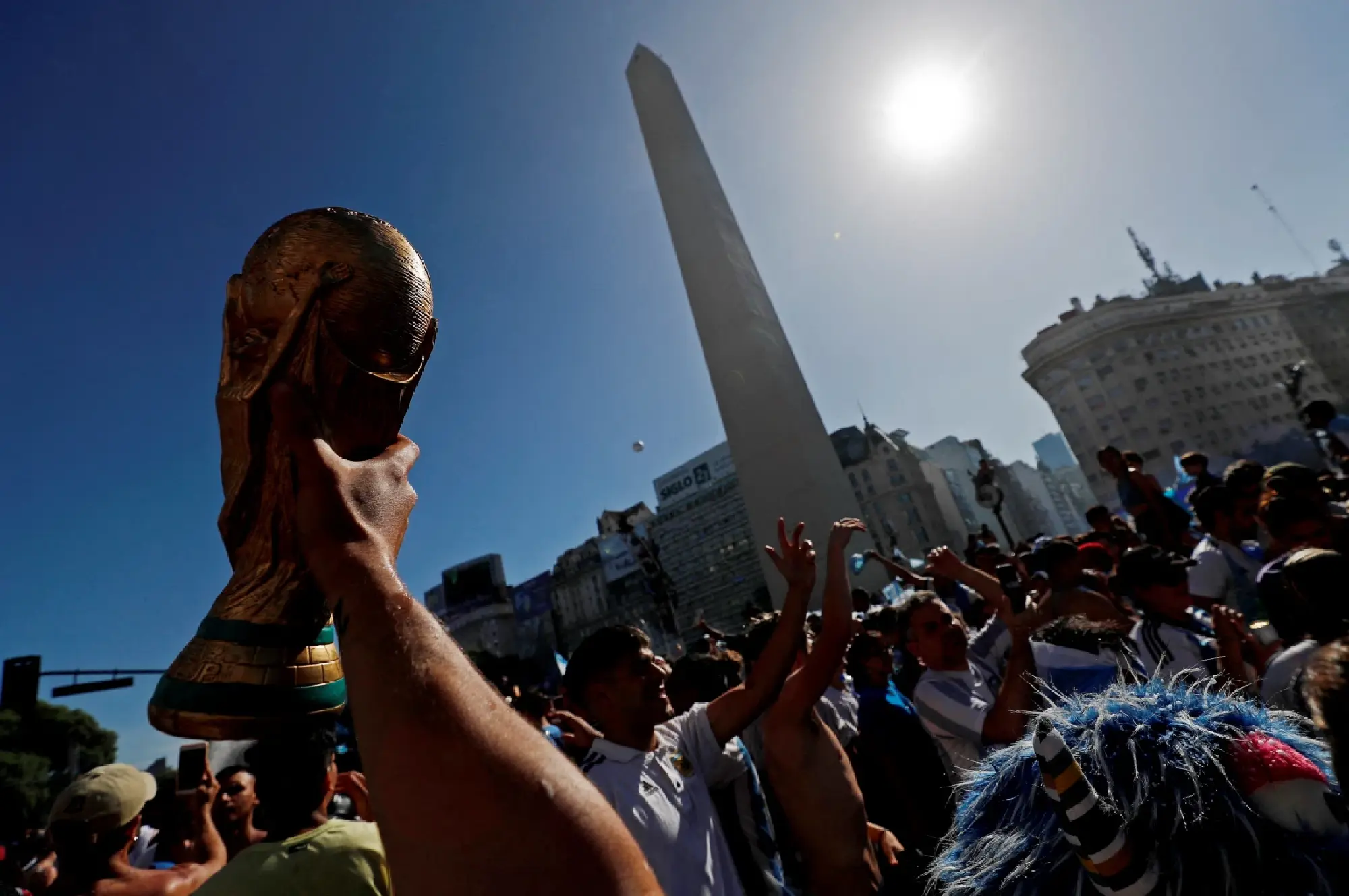 Argentina fans celebrate winning the World Cup at the Obelisk with an image of Lionel Messi 