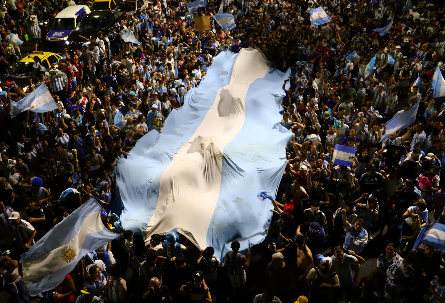 Fans gather outside of the Association of Argentinian Football Headquarters ahead of the team arrival