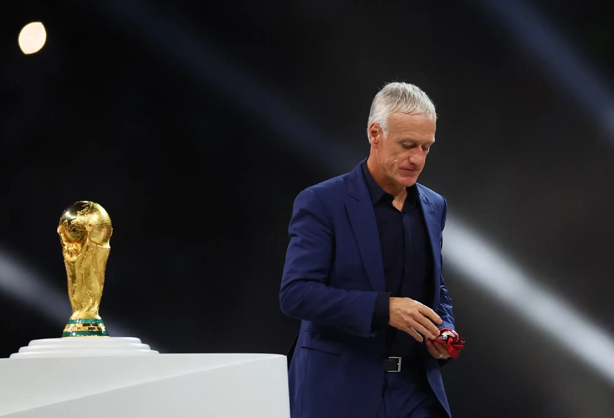 France coach Didier Deschamps walks past the World Cup trophy after receiving the silver medal