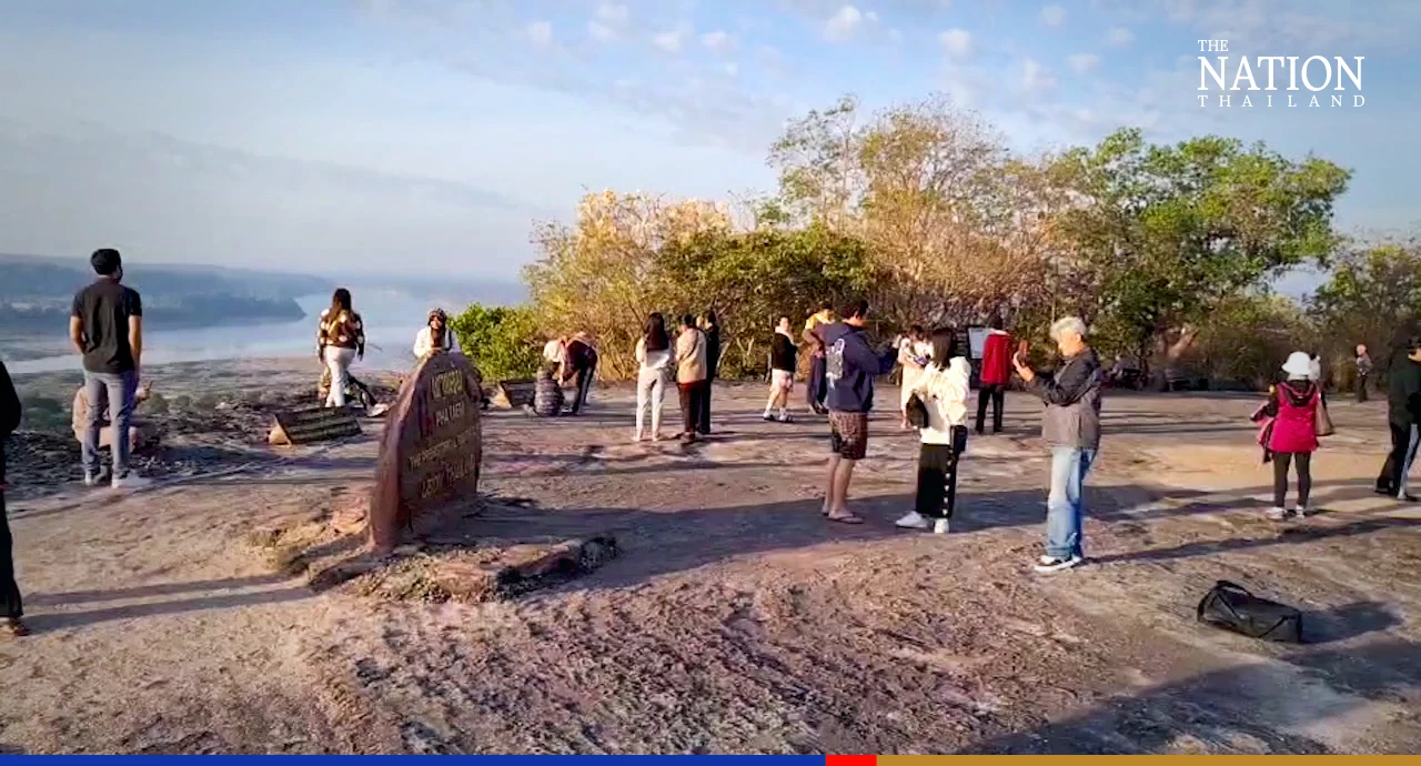 Tourists gather on a sacred mountain in Ubon for New Year sunrise