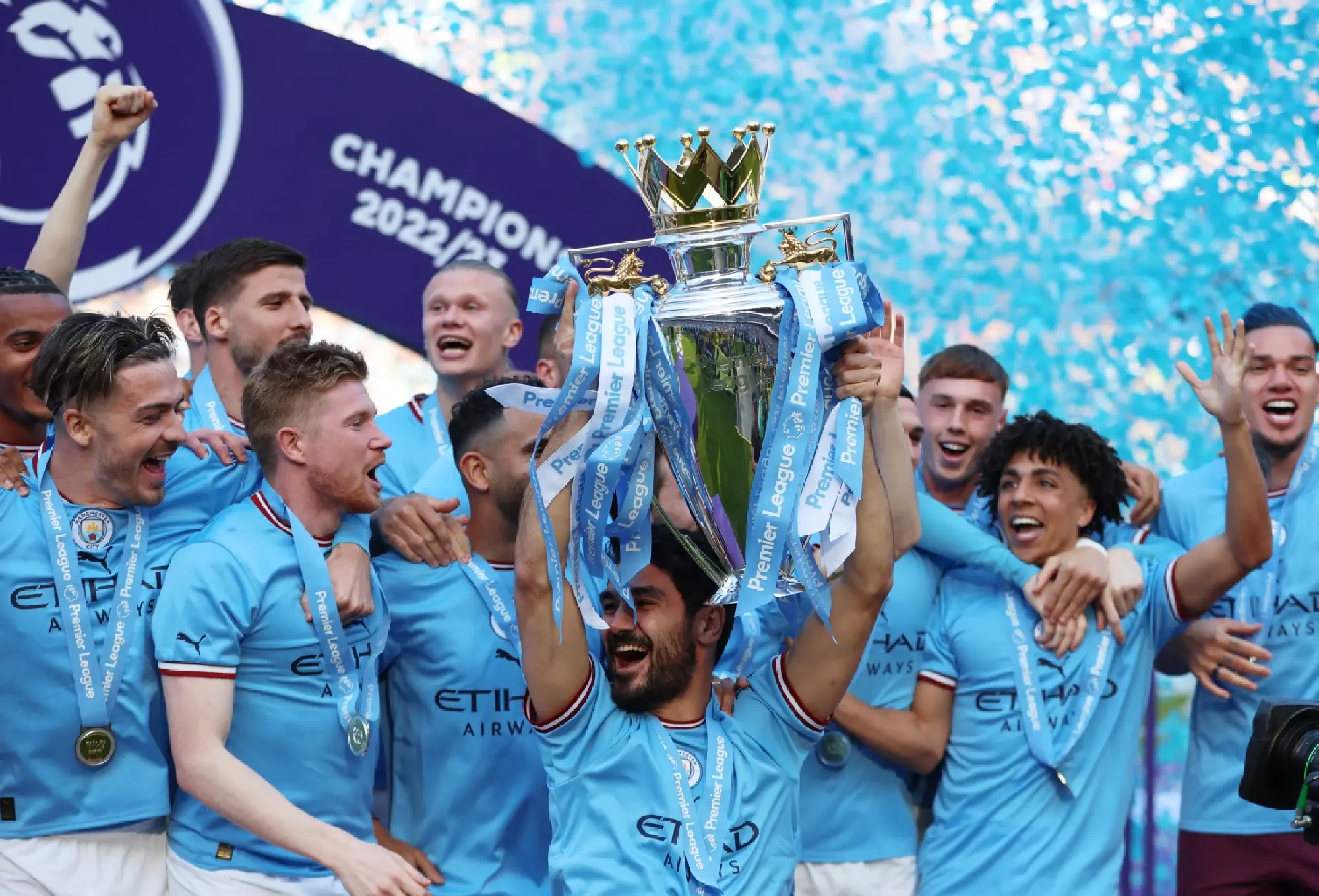 Ilkay Gundogan lifts the trophy as he celebrates with teammates after winning the Premier League
