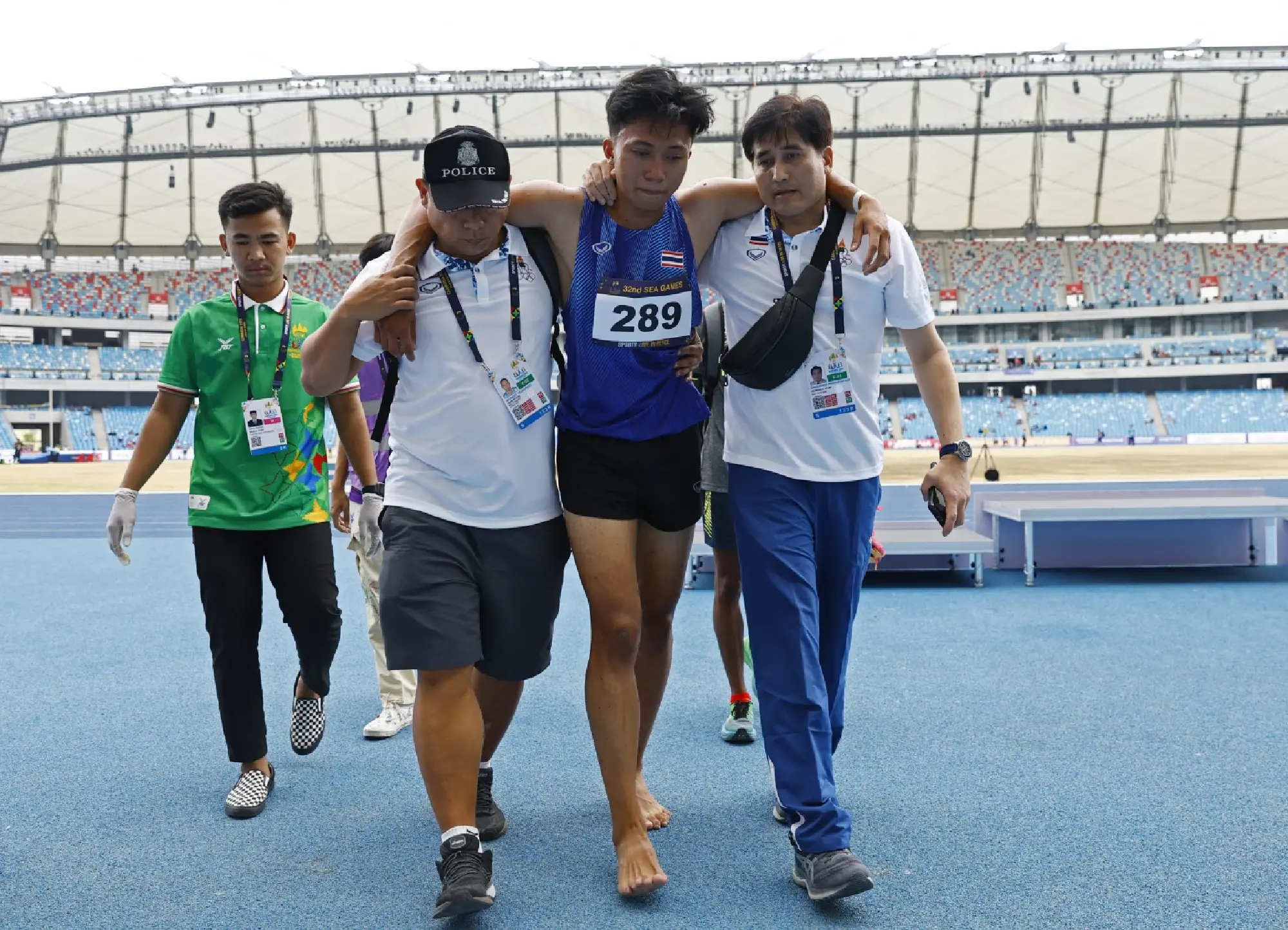 Thailand's Puripol Boonson is helped from the track after sustaining an injury during the men's 200m final