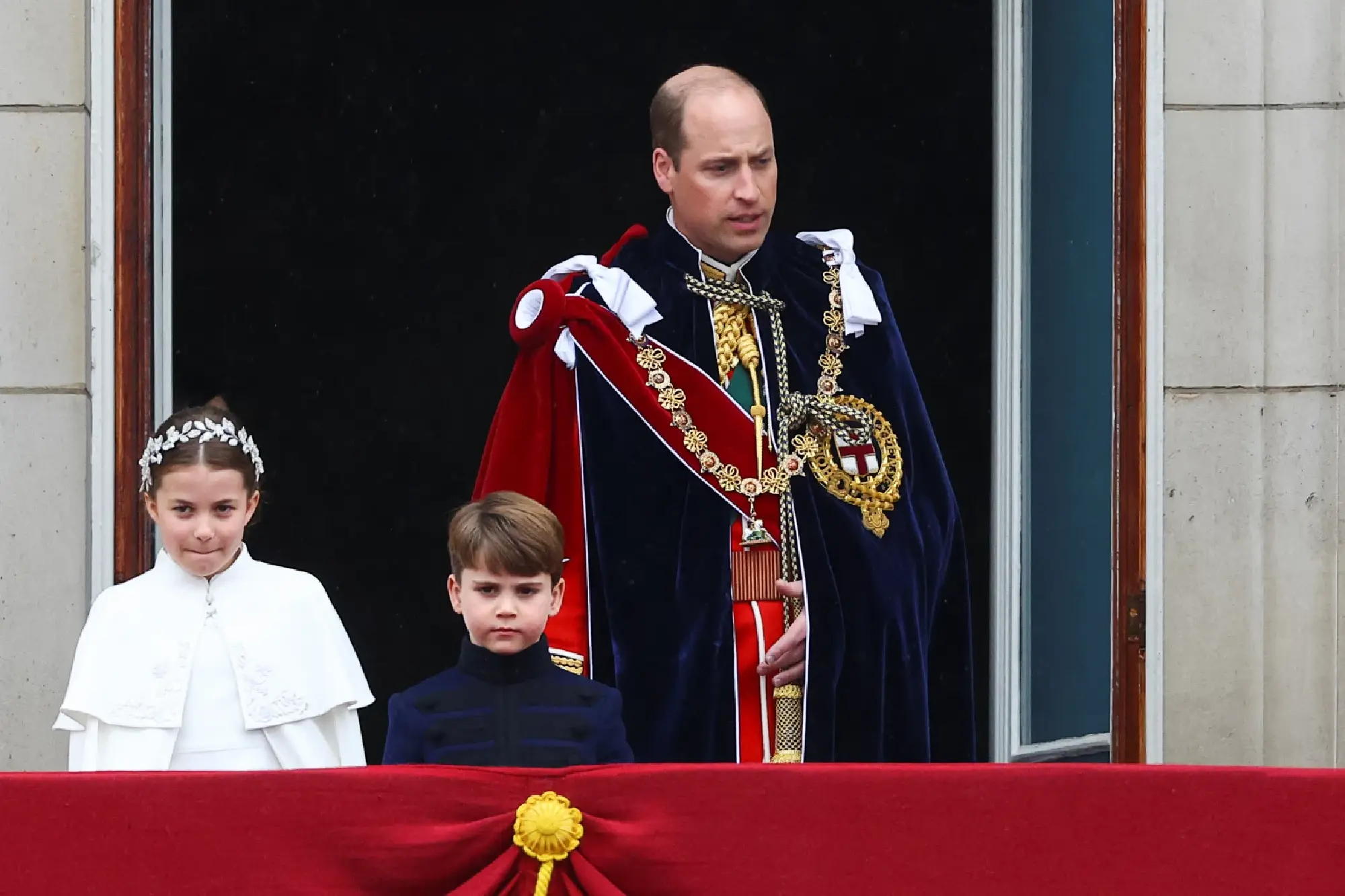 Britain's Prince William, Princess Charlotte and Prince Louis stand on the Buckingham Palace balcony following Britain's King Charles' coronation ceremony in London
