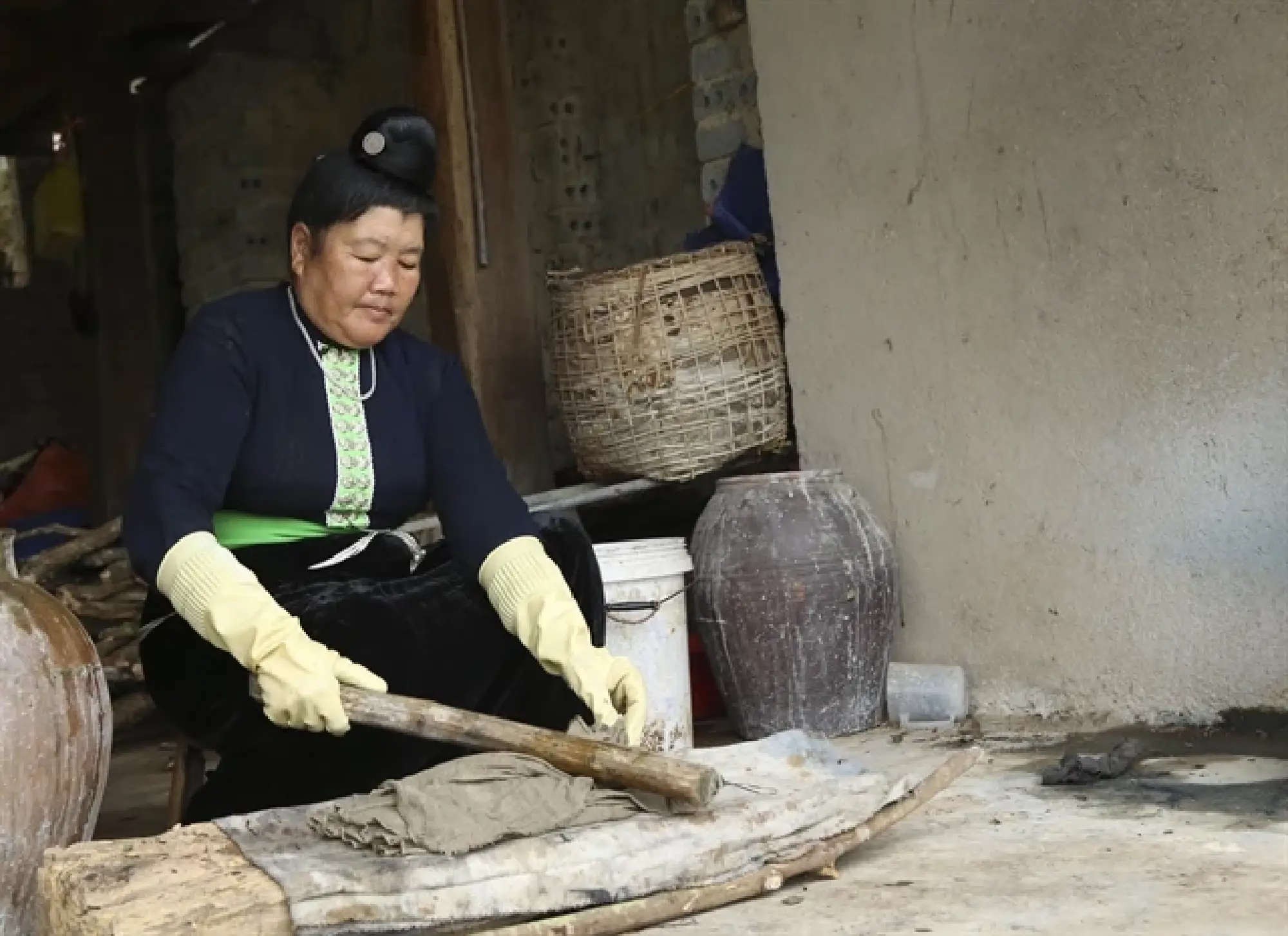 The fabric after being dipped in indigo is squeezed and beaten with a pestle so that the colour is evenly absorbed. VNA Photos Xuan Tư