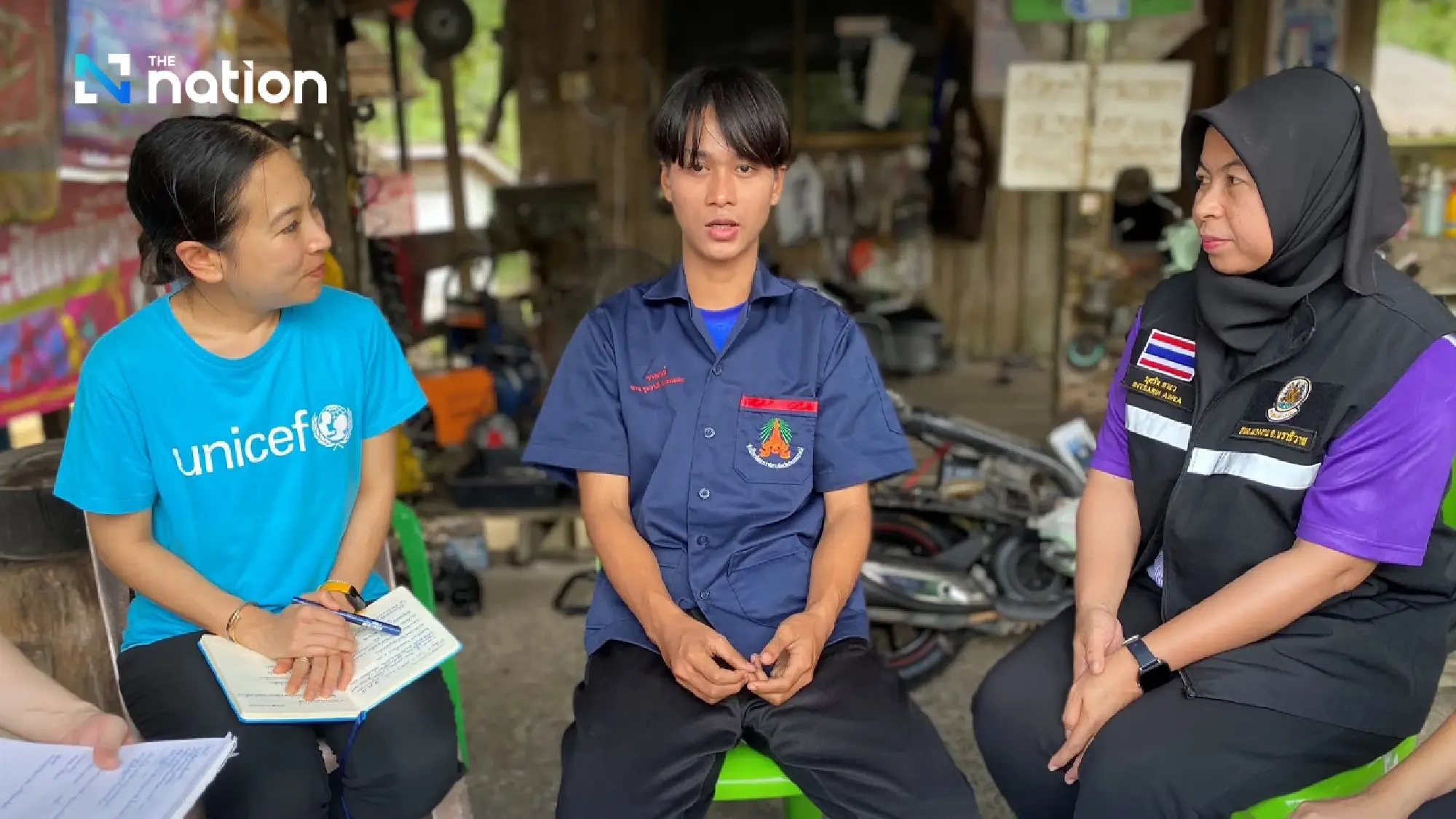 Labour graduate Butsarin Awea visits Ruswadee at the garage where he’s doing his internship.