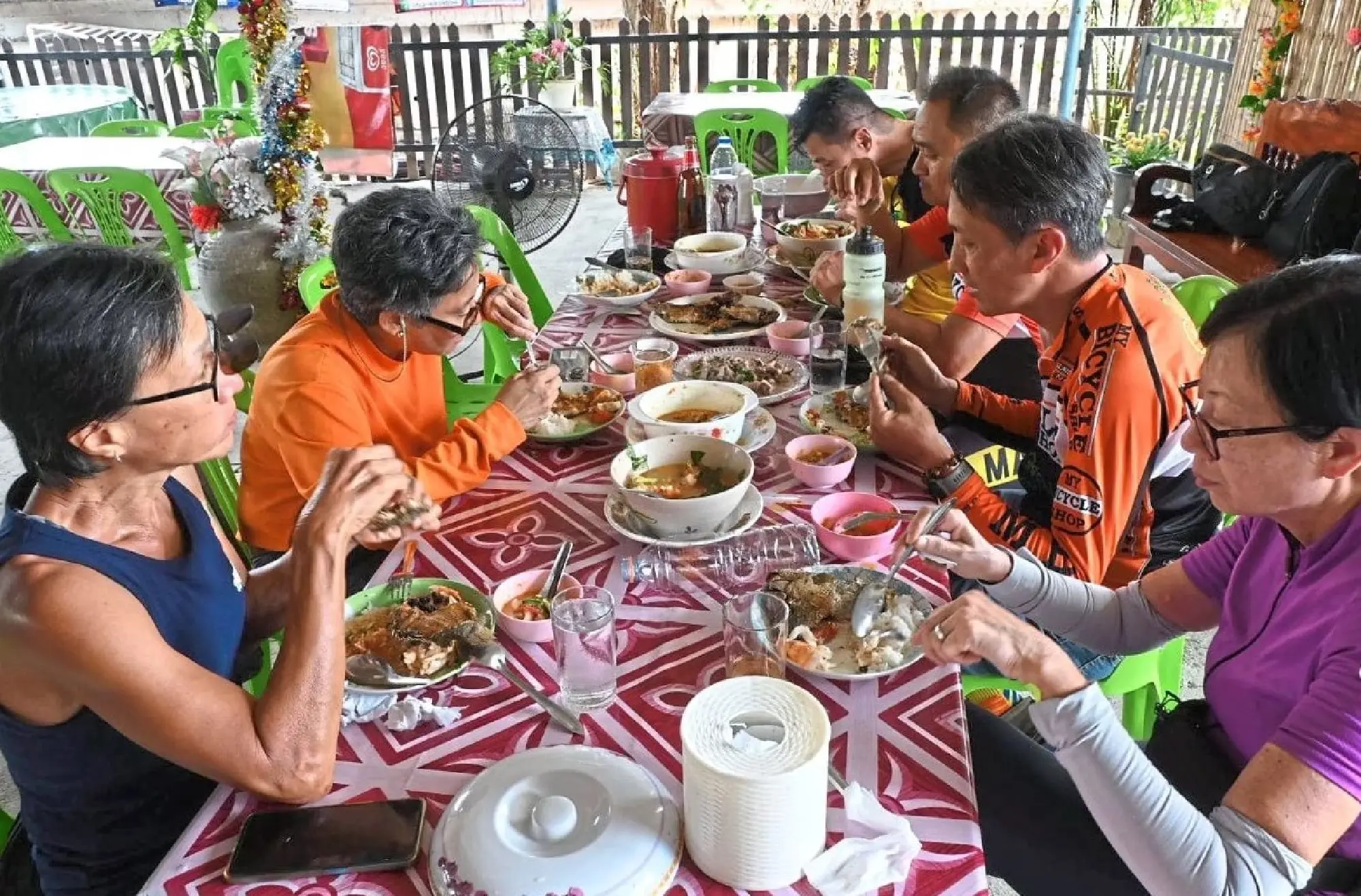 Cyclists having a sumptuous lunch break after covering a distance of 96km from Songkhla to Ranot.
