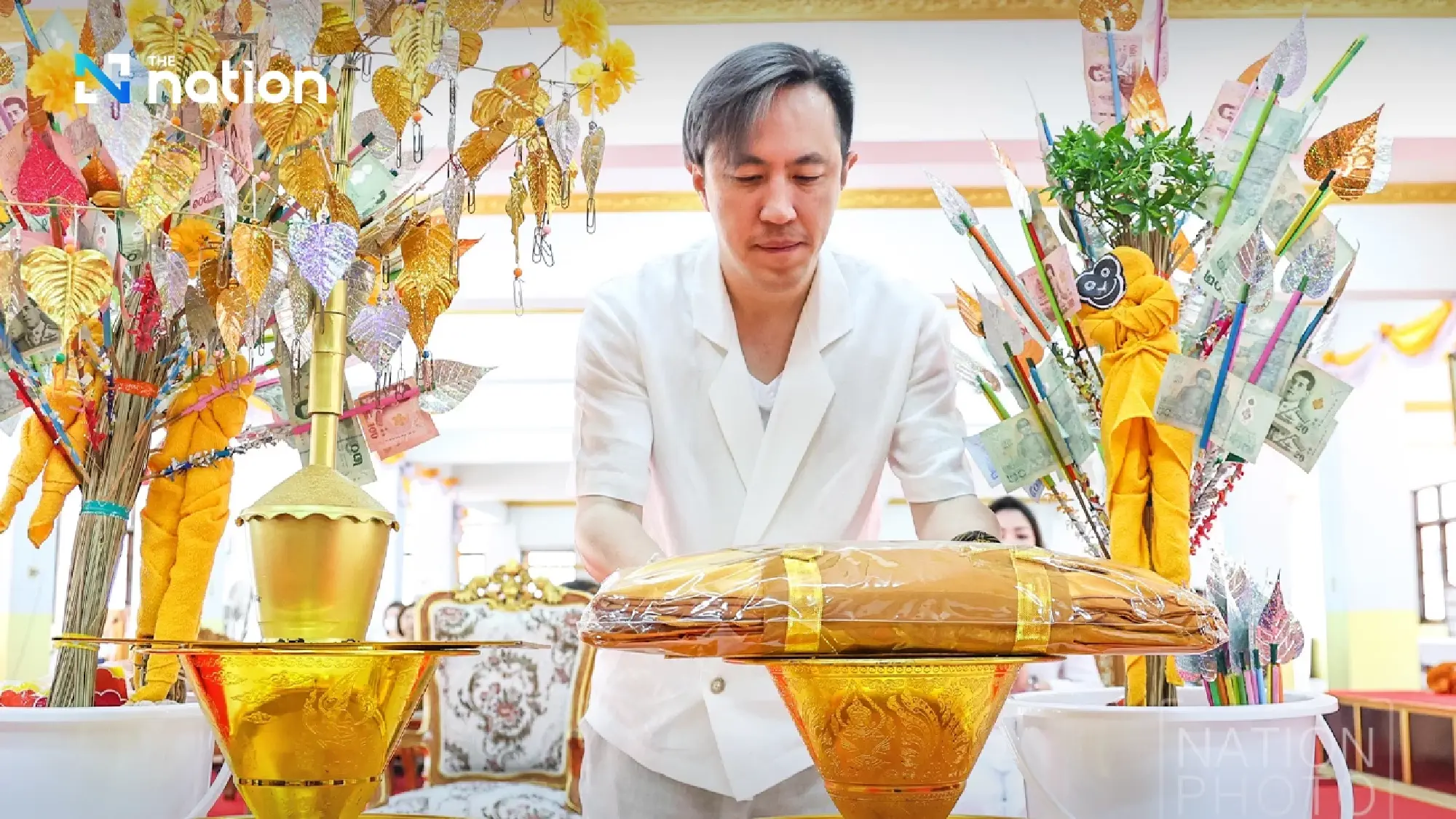 Shine Bunnag leads Nation Group executives in robe offering ceremony