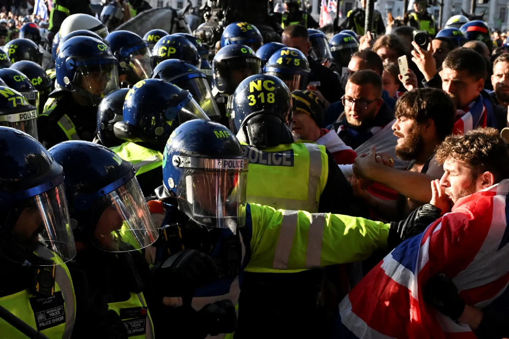 Police and protesters scuffle as 110,000 join anti-migrant London protest