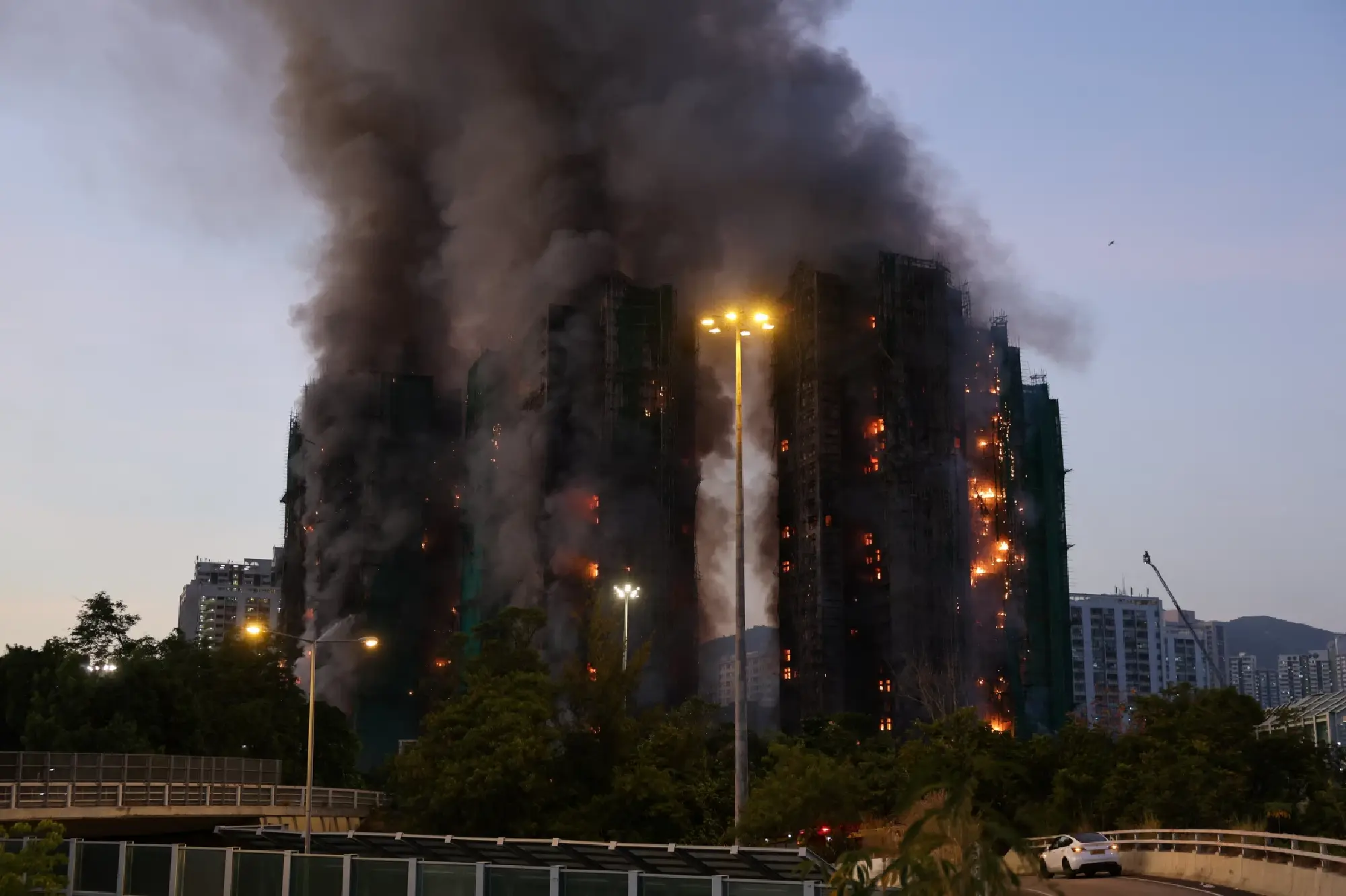 At least 14 killed in Hong Kong high-rise fire as flames engulf residential towers