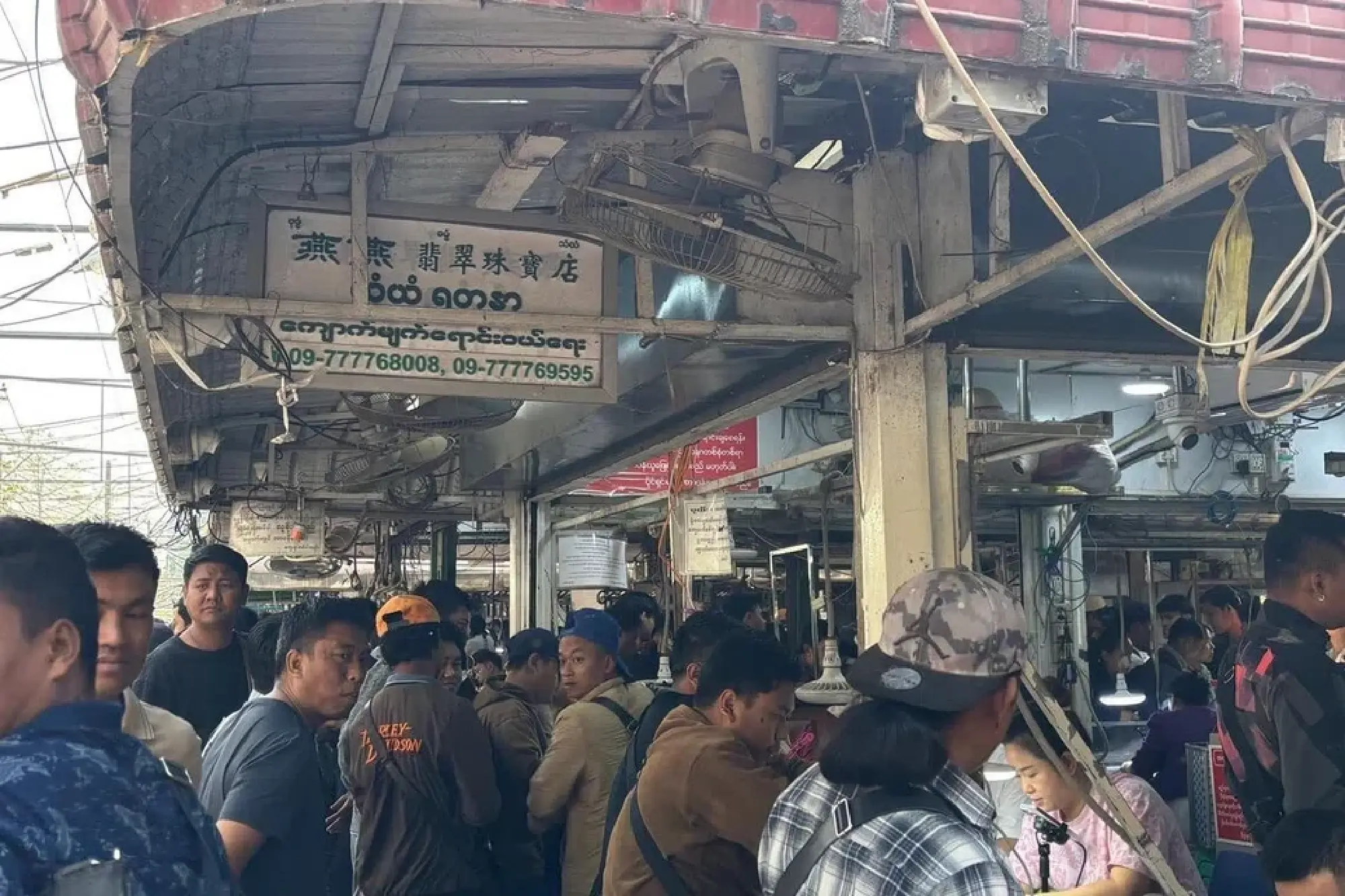 Chinese brokers shine LED torches and peer through magnifying glasses to appraise items from uncut stones to finished pieces of jewellery.  ST PHOTO:PHILIP WEN