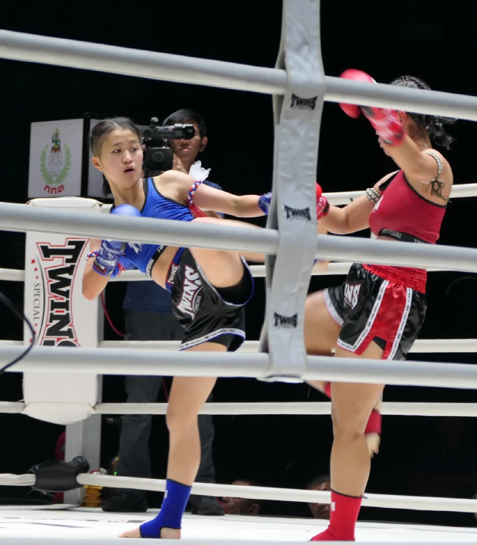 Japan's 15-year-old Muay Thai competitor Airi Kadowaki (left), fights in her professional debut match at Bangkok's prestigious Lumpinee Boxing Stadium on Nov. 29.