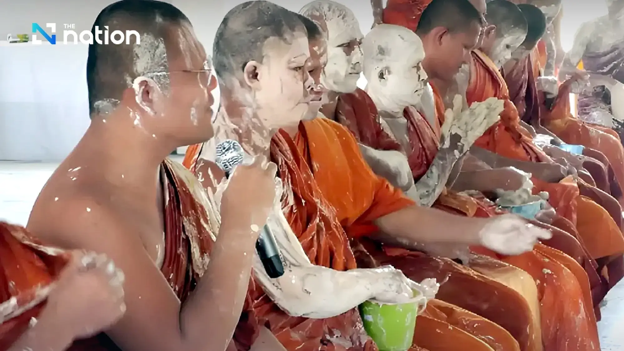 Surin monks covered in white powder during Songkran rite