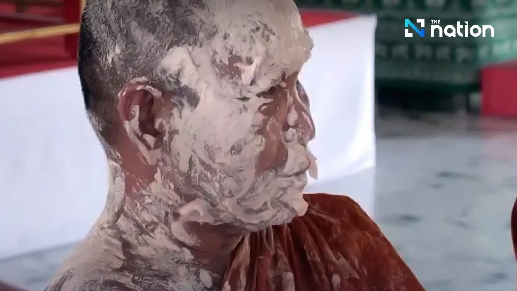 Surin monks covered in white powder during Songkran rite