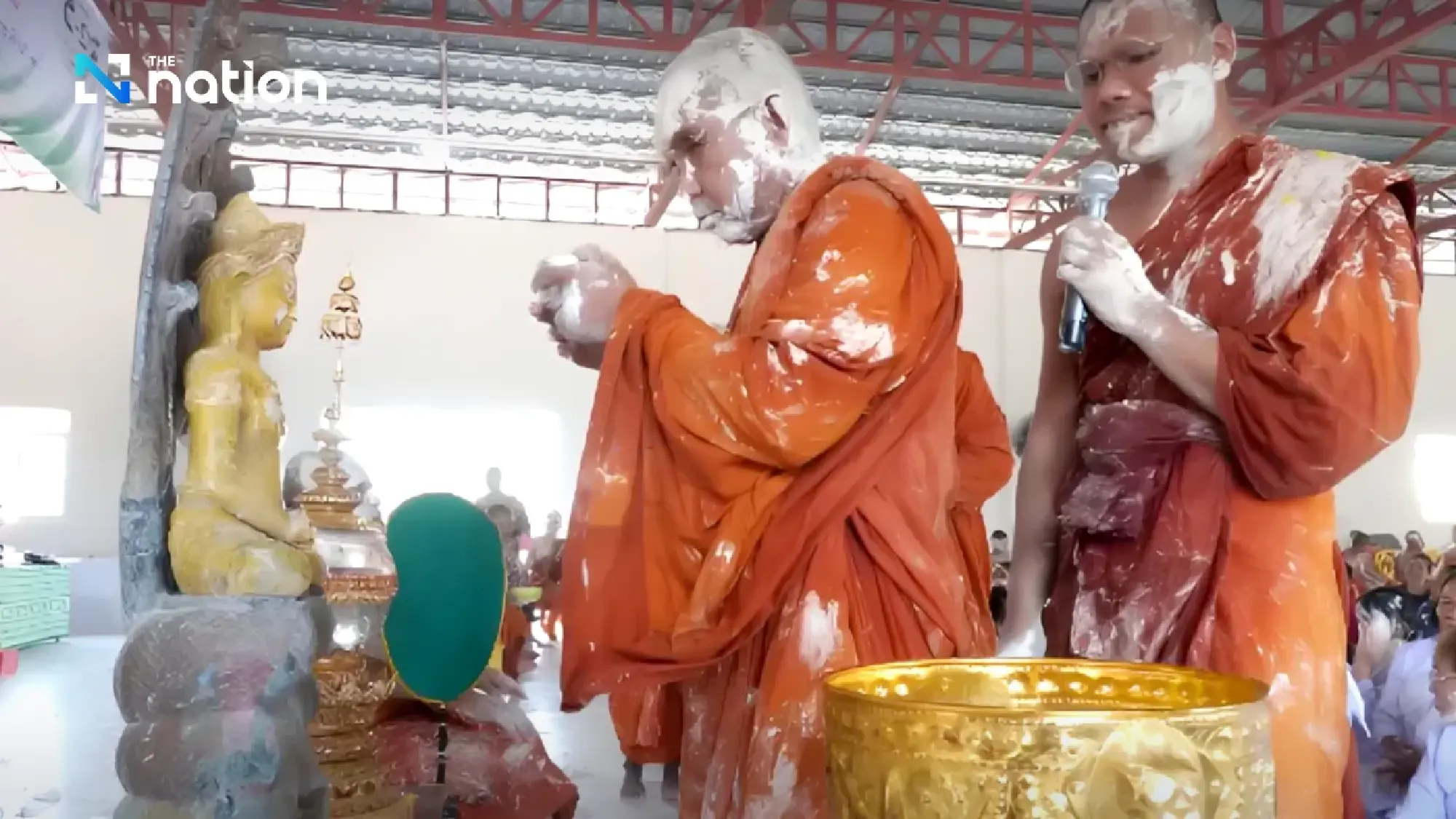 Surin monks covered in white powder during Songkran rite