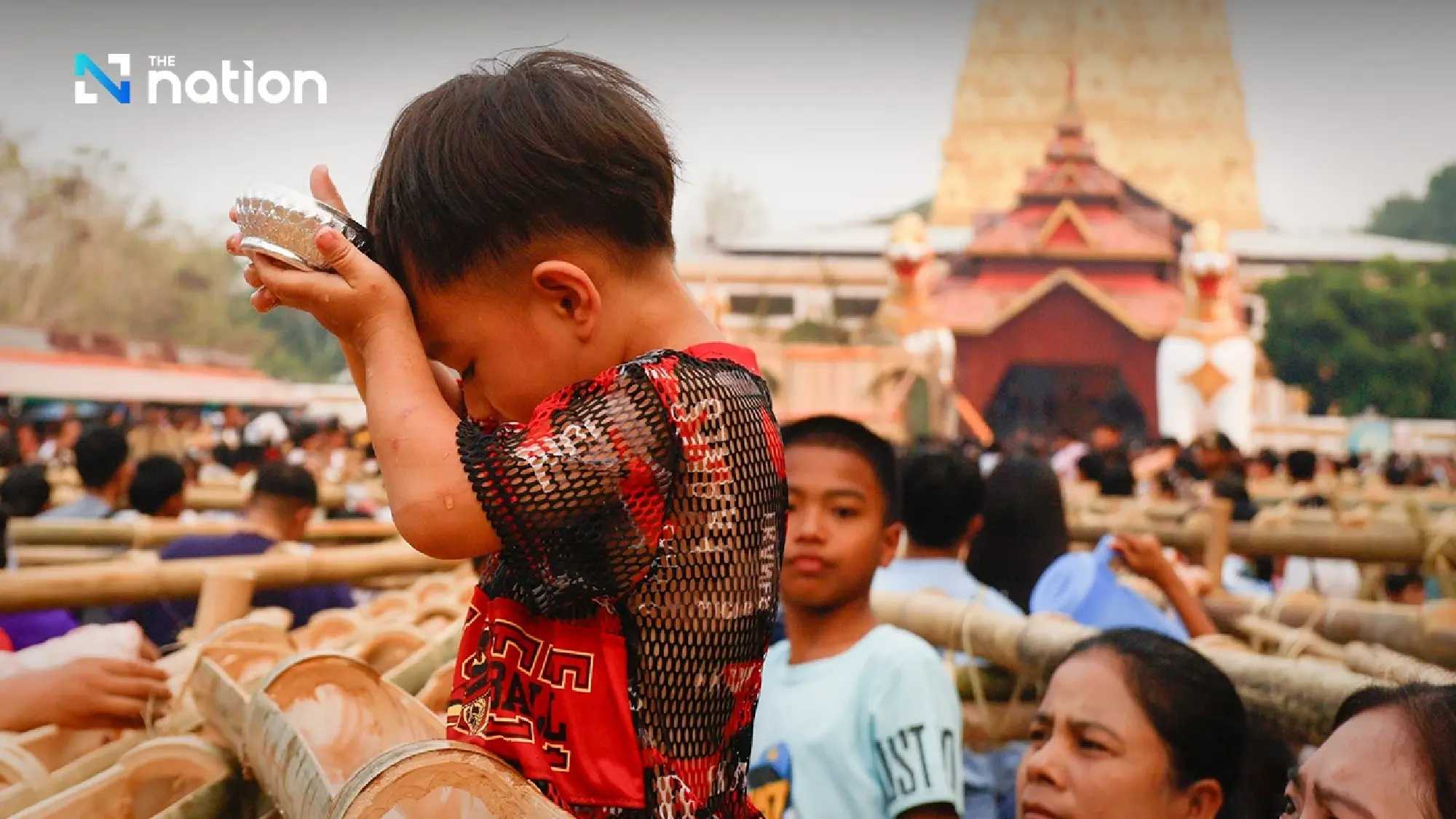 One of a kind tradition: Mon Songkran rite bathes monks through bamboo channels