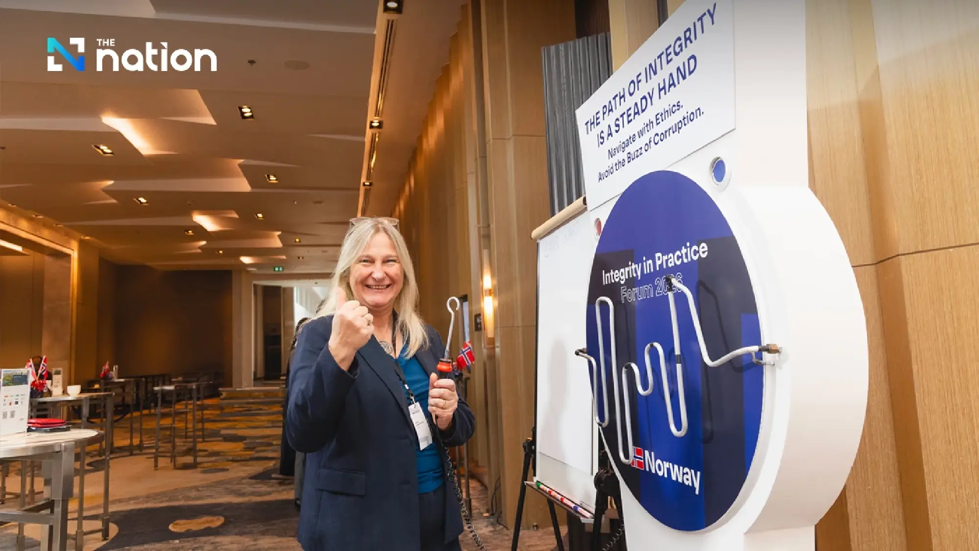 An attendee tests their steady hand at "The Path of Integrity" interactive game