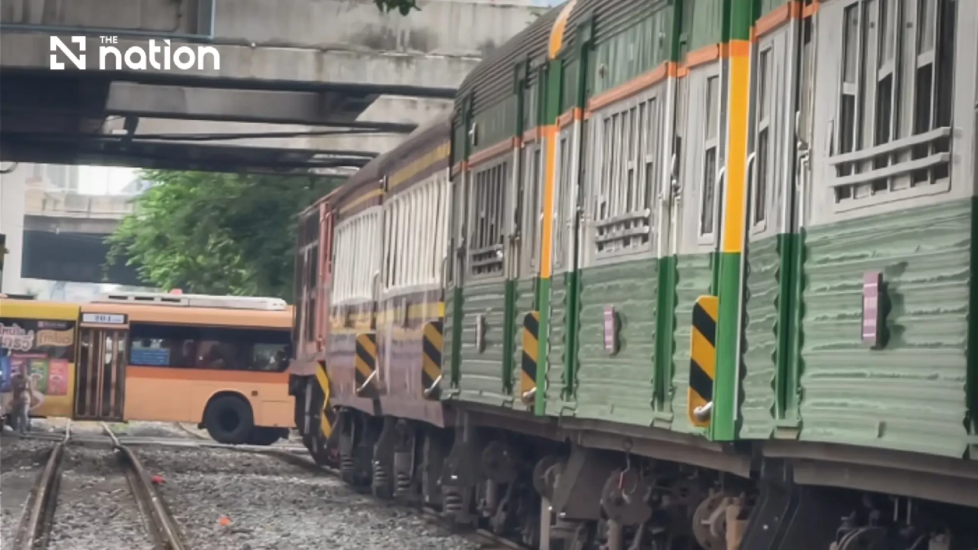 Bangkok bus stranded on tracks as traffic suddenly stops