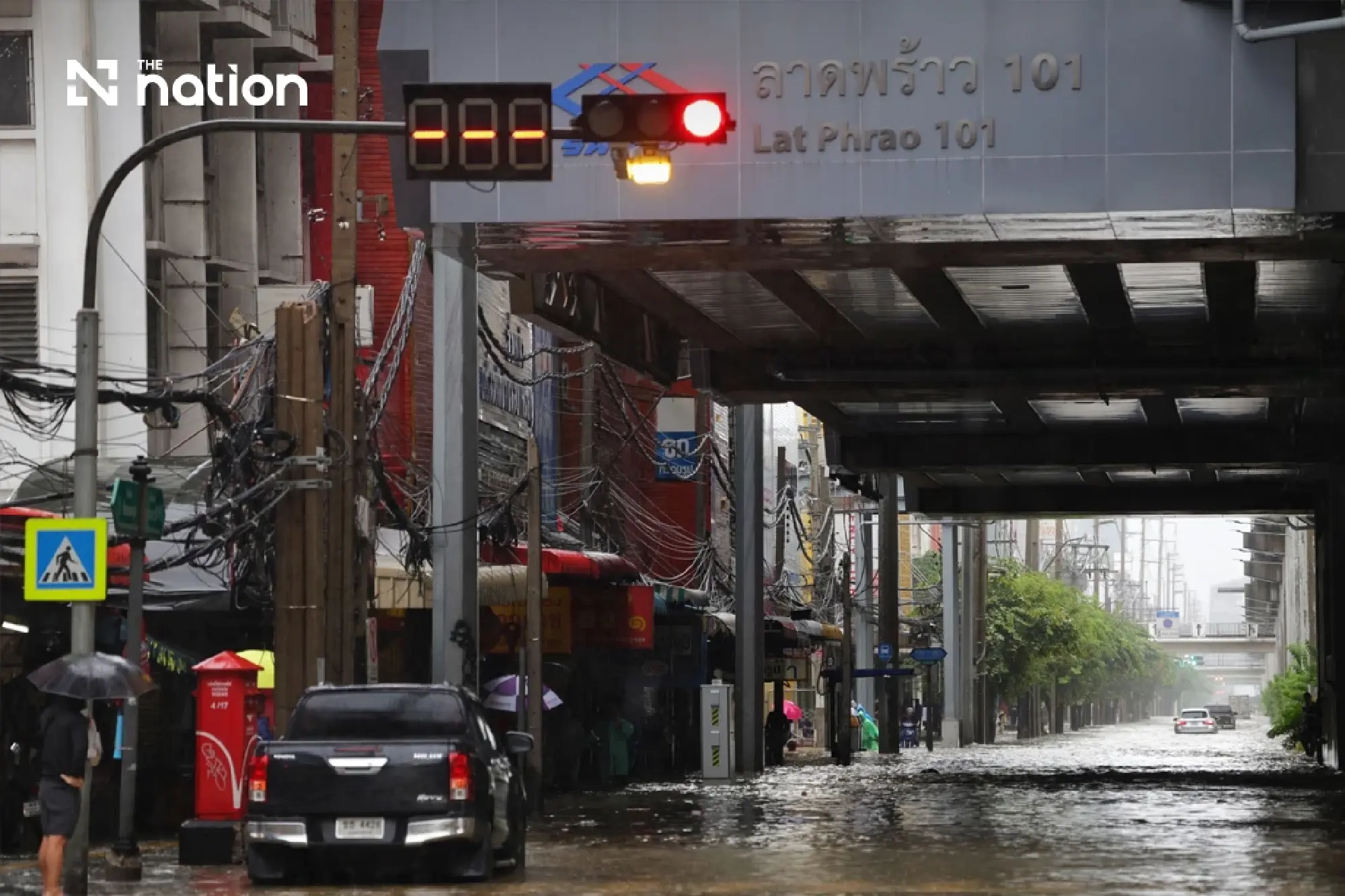 Floods block small cars on Bangkok’s Lat Phrao as storms forecast across 80% of area