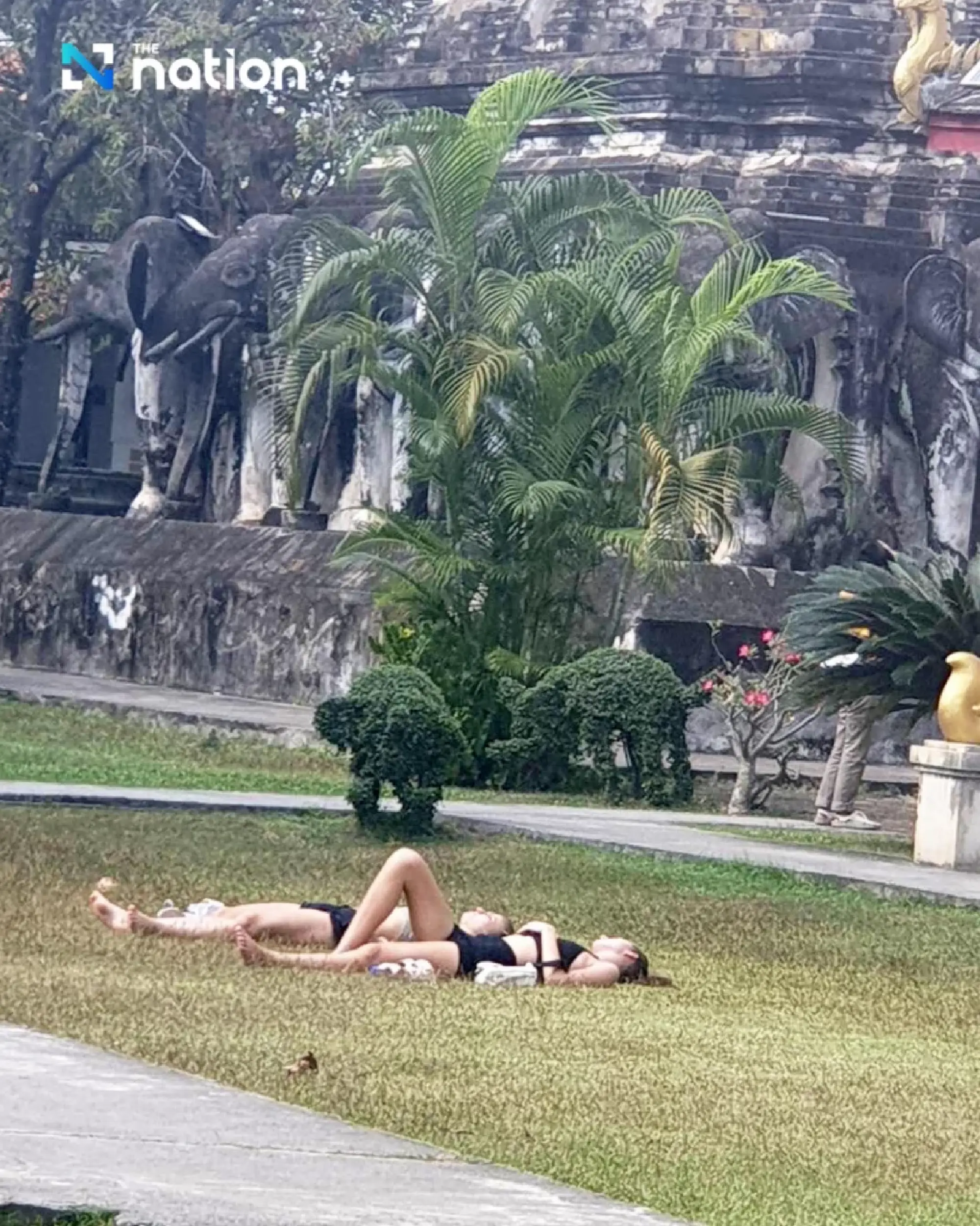 Social media explodes over foreign sunbathers at Chiang Mai temple - Photo 4