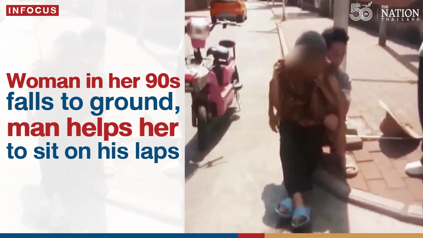 Woman in her 90s falls to ground, man helps her to sit on his laps