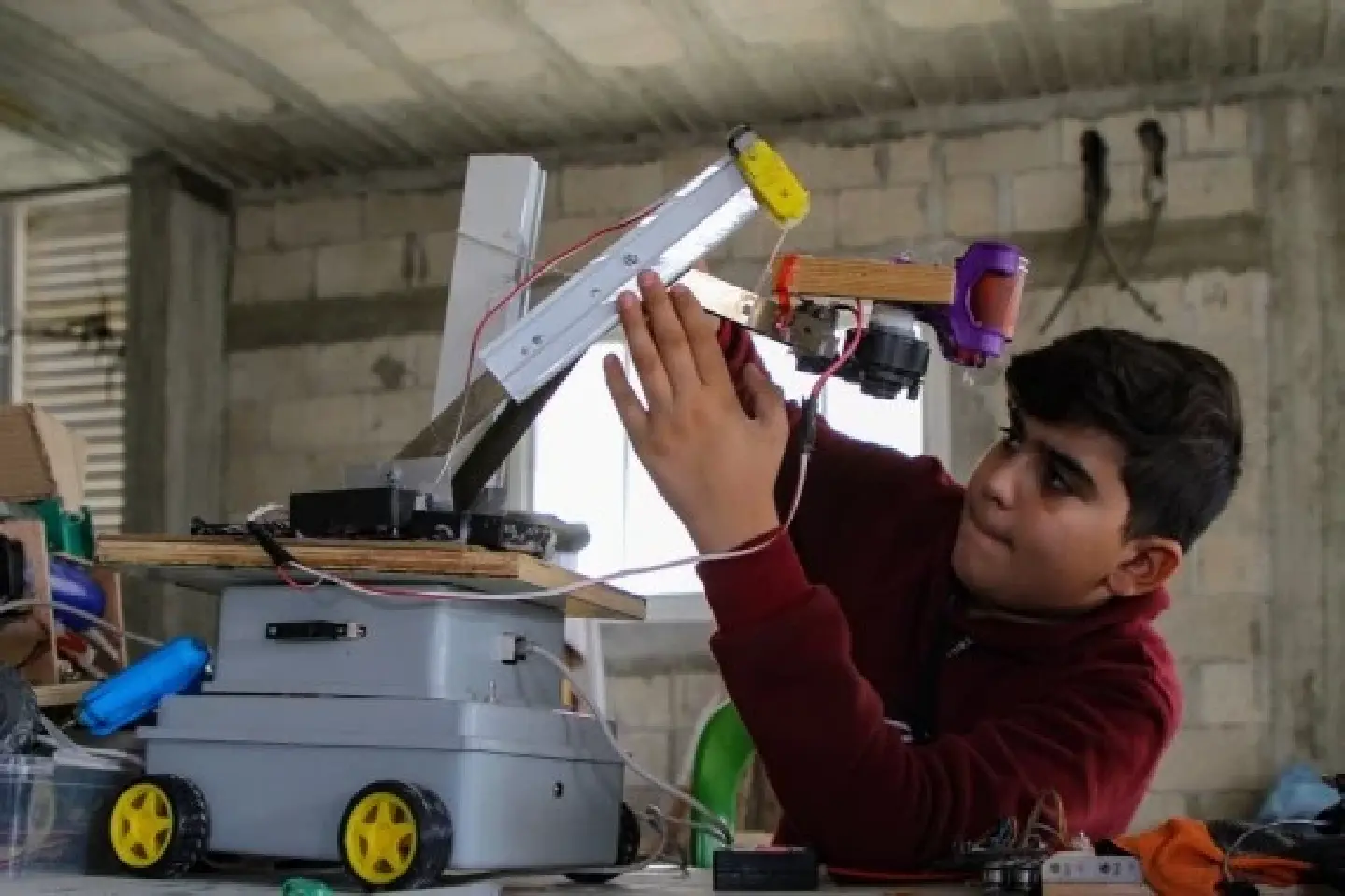 Palestinian child makes robots, electronic devices with simple tools