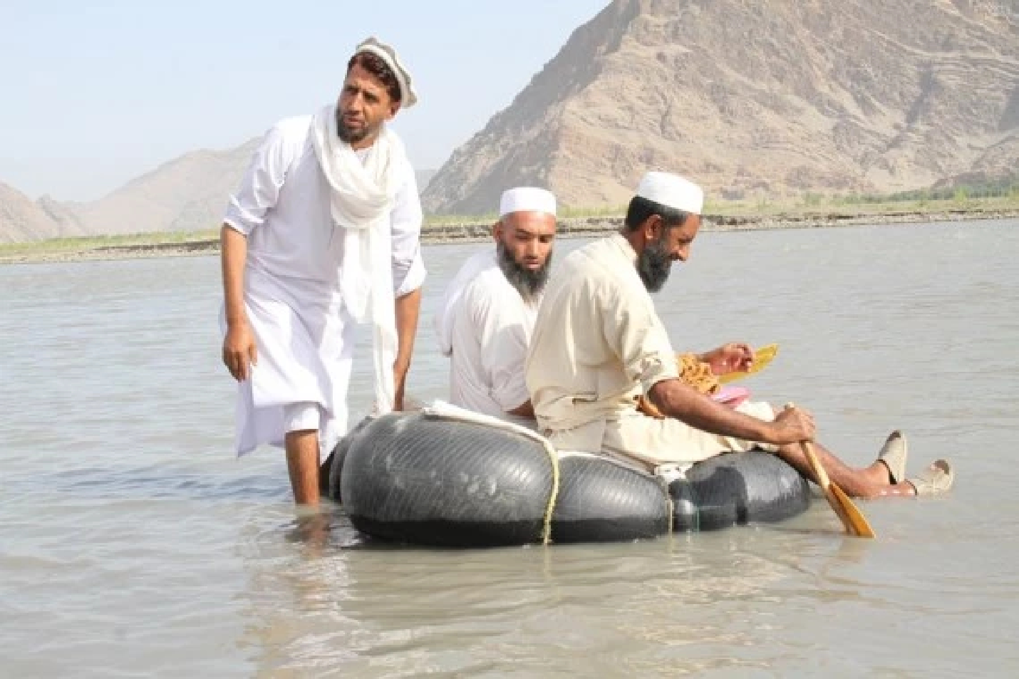 Afghan teachers use leather rafts to get to school