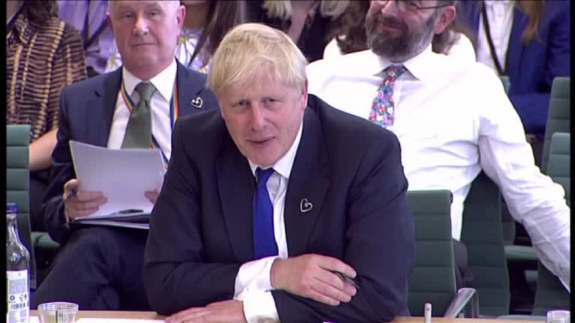 Boris Johnson defies calls to resign amid mass exodus