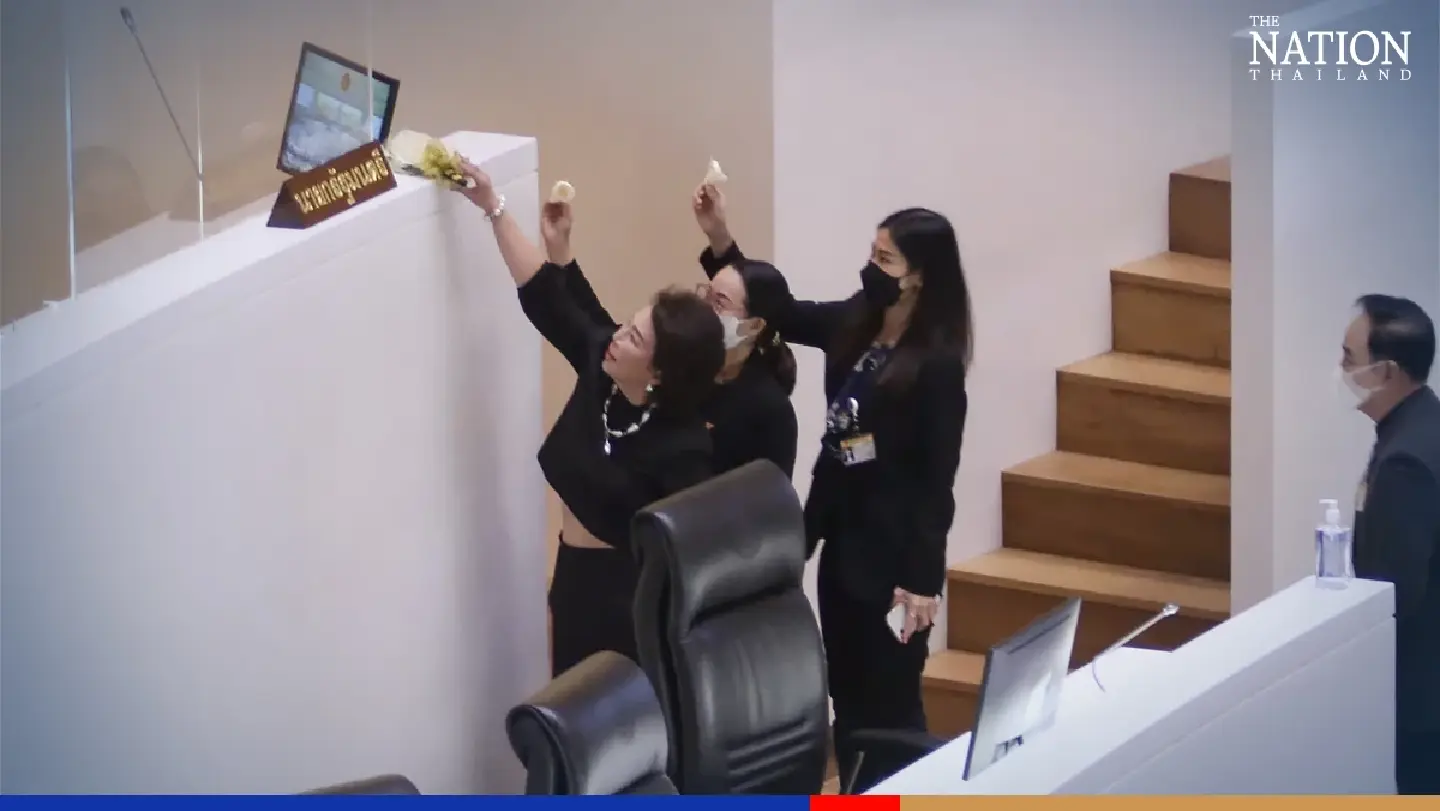 Opposition MPs place cremation flowers at Prayut’s Parliament podium Opposition MPs place cremation flowers at Prayut’s Parliament podium