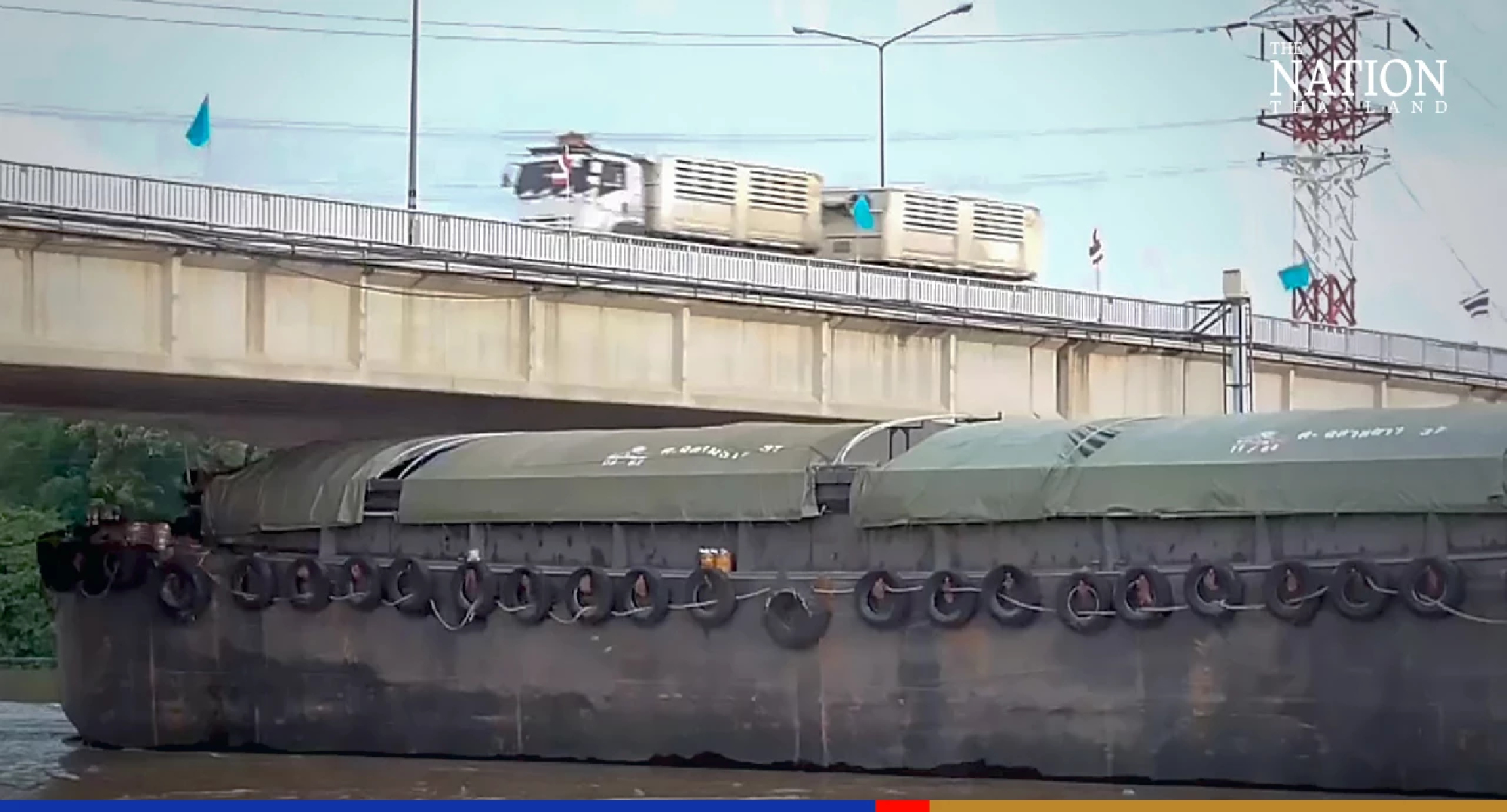 Cargo ships crawl under Ang Thong bridges as Chao Phraya rises