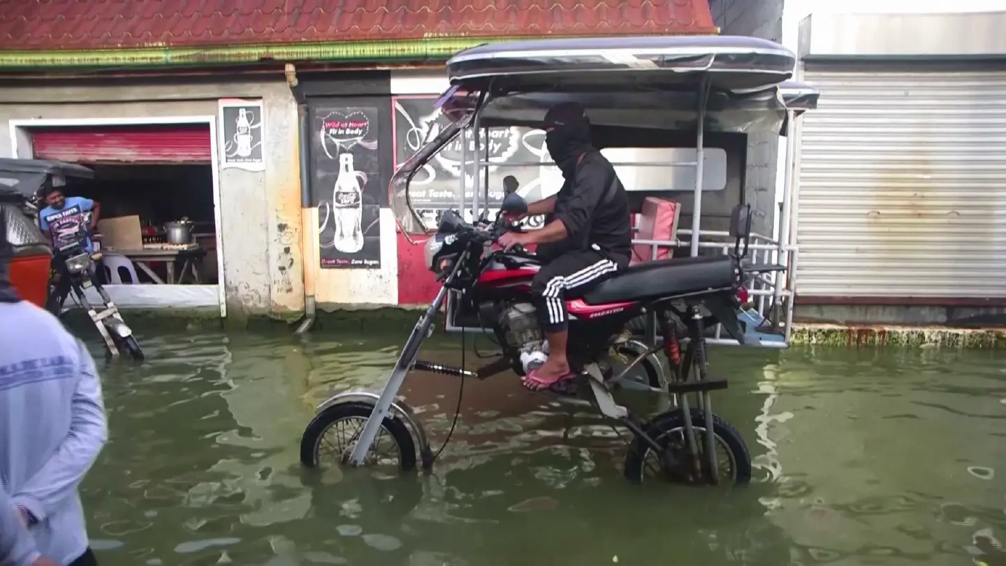 Philippine locals ride high and dry as taxis find ingenious flood solution