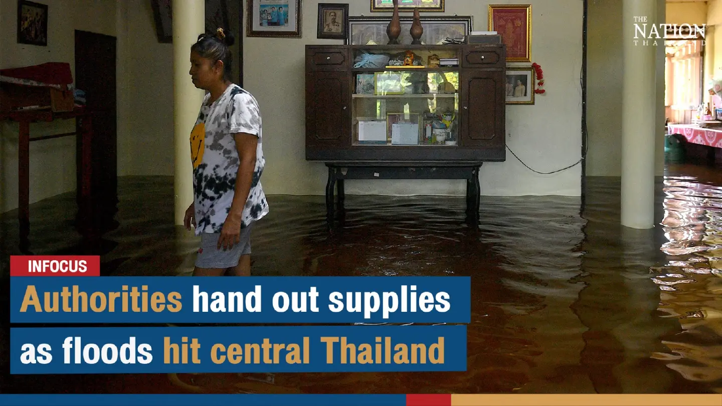 Officials battle through chest-high floods to deliver relief supplies in Central Thailand