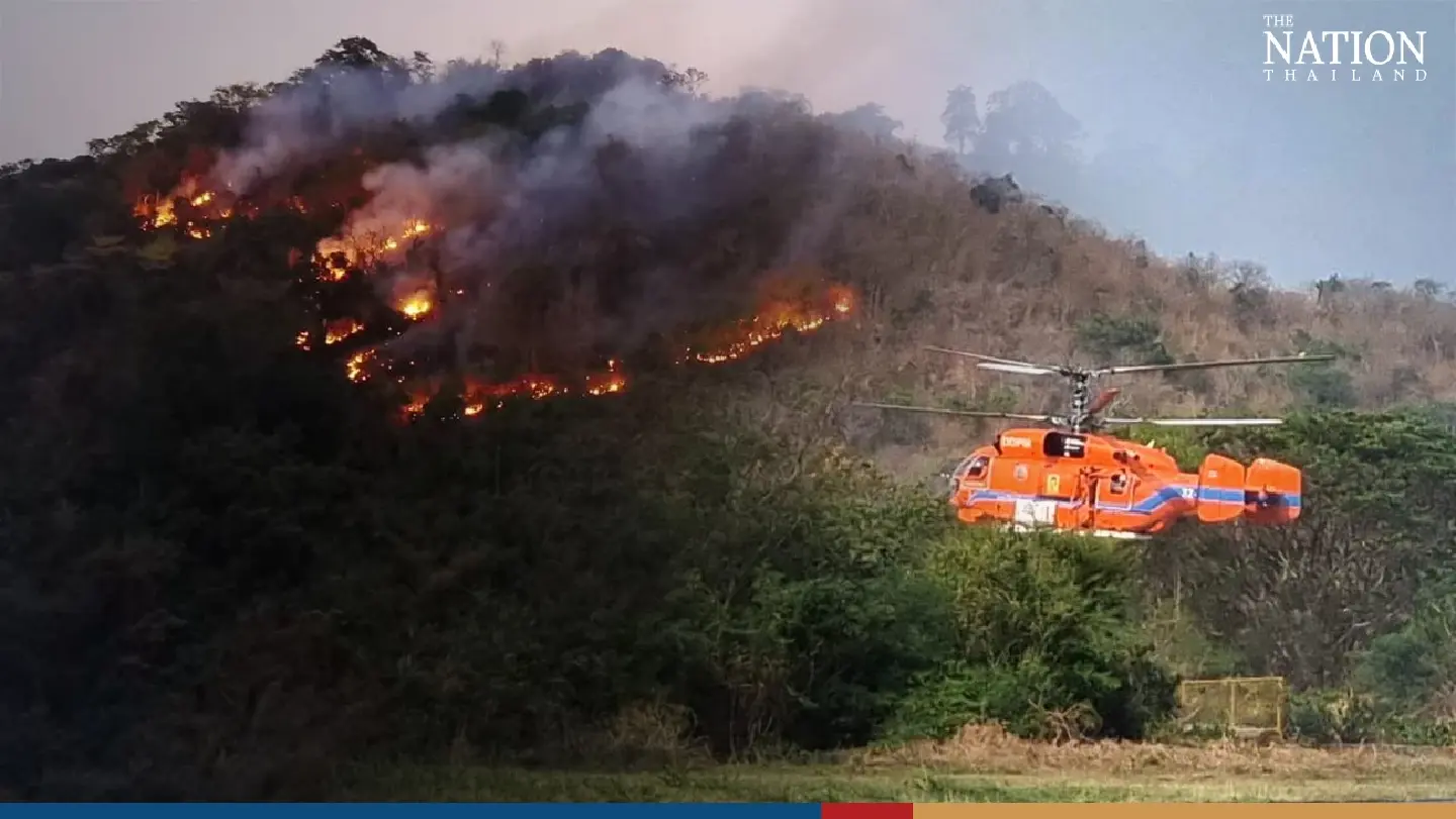 Firefighters, helicopter battling huge forest fire near military academy