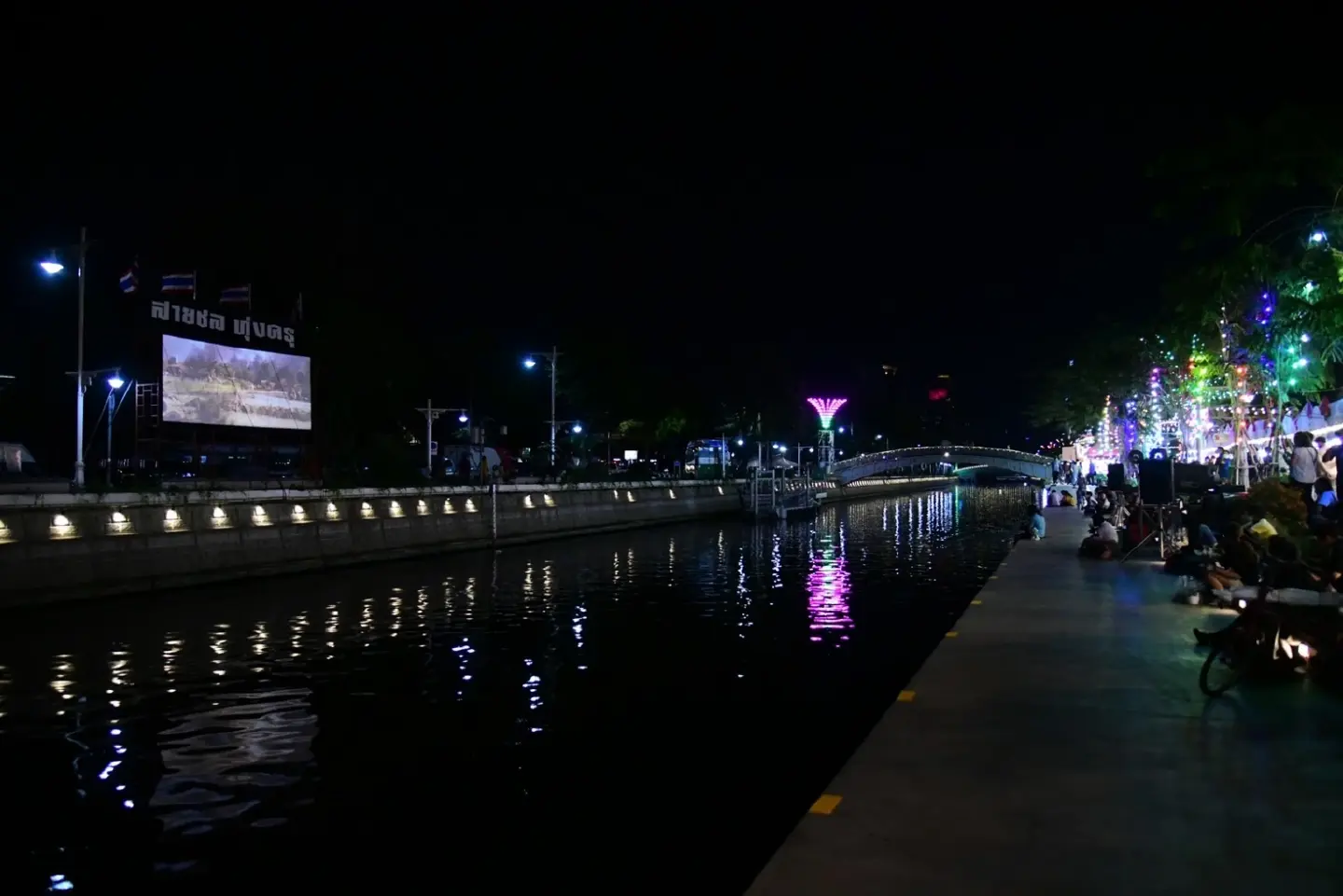 Bangkok canal lights up with vendors, live music, art, and open-air cinema