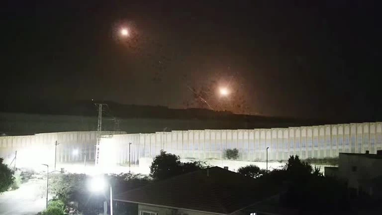 At midnight rocket launches and flares illuminate sky over Israel-Gaza border