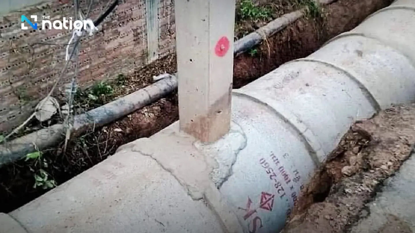 People query logic behind power pole going through roadside drainage in Si Sa Ket