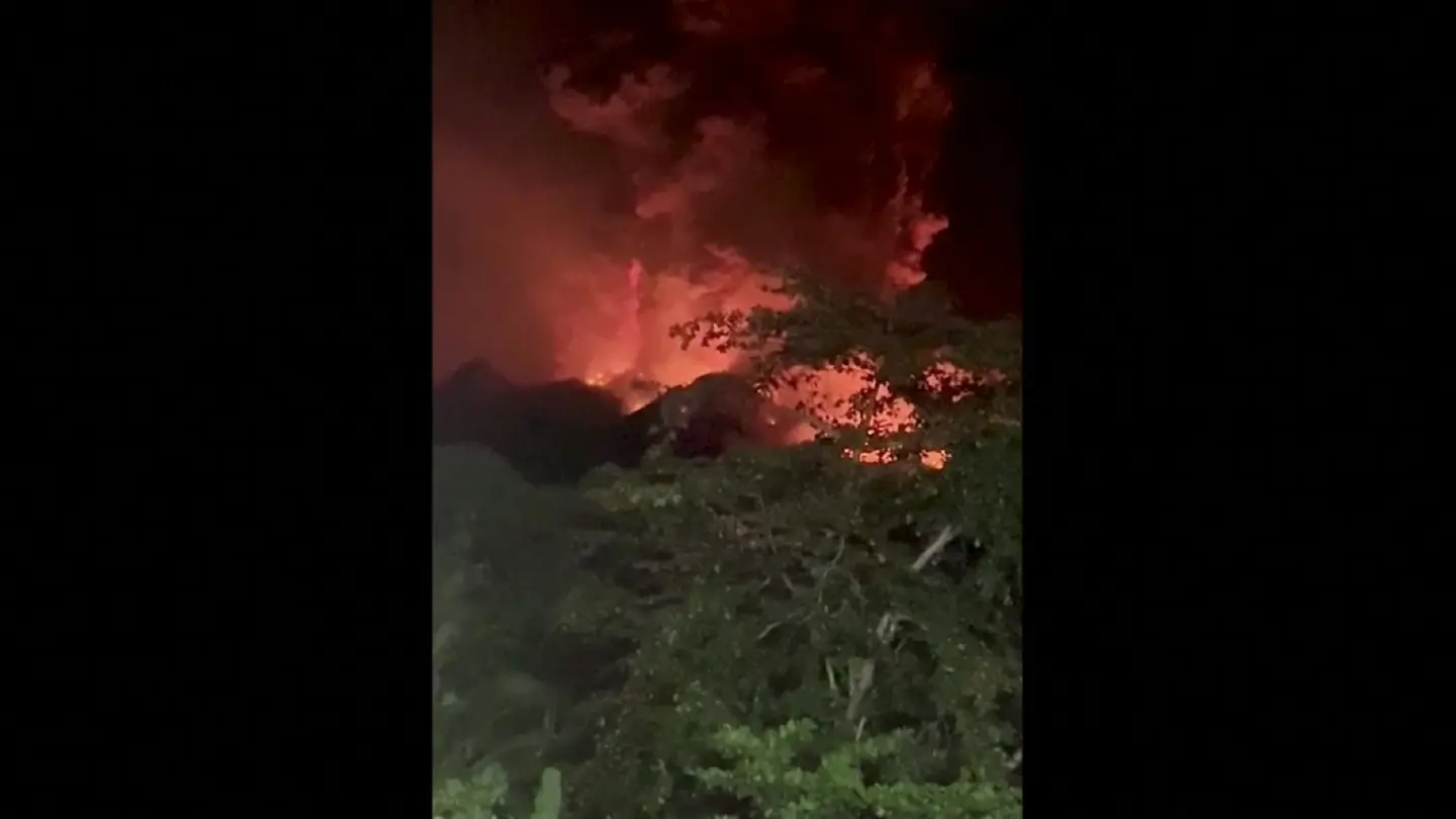 Indonesians leave homes near erupting volcano and airport closes due to ash danger