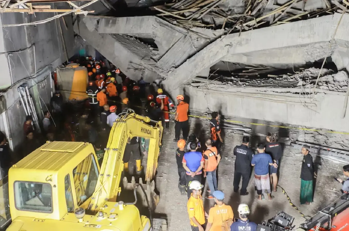 Relatives weep for scores of missing children after deadly Indonesia school collapse