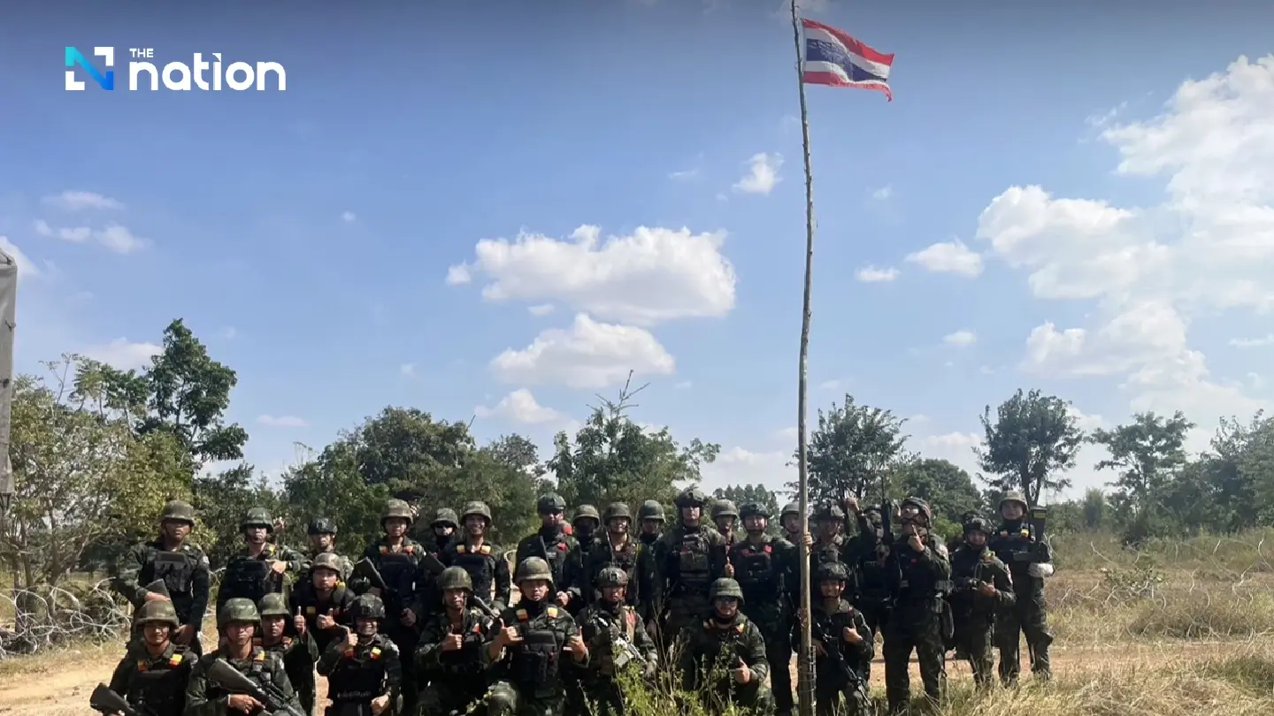 Thai troops raise national flag after reclaiming territory from Cambodia in Ta Phraya, Sa Kaeo